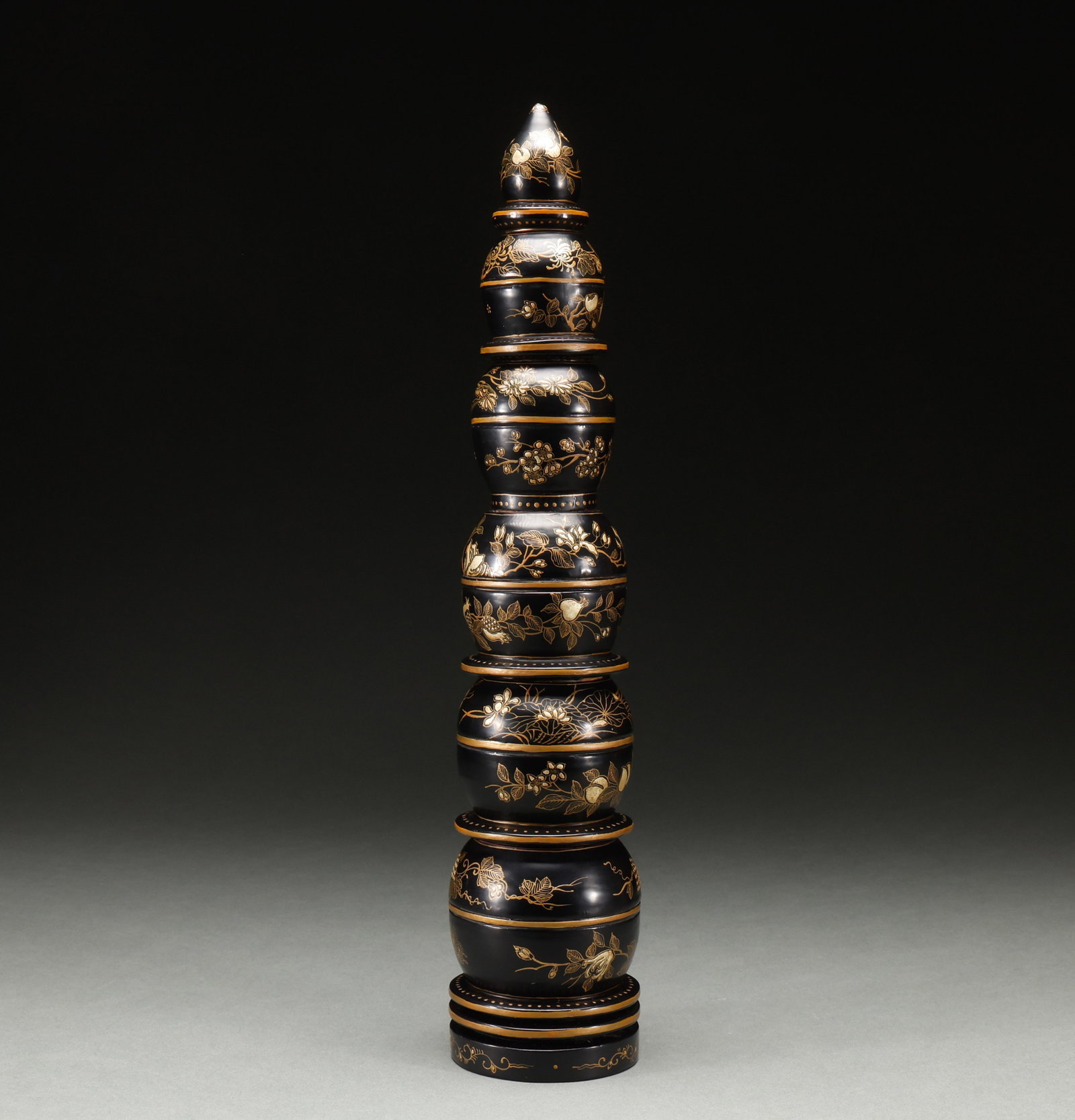 Qing Dynasty black lacquer painted golden gourd shaped tower: Qing-Dynasty Black Lacquer Gilded Gourd-Shaped Pagoda. Meticulously worked with singular artistry, the piece stands 10 cm tall, is 8 cm wide, and weighs 312 g. The modeling is refined and the ornament