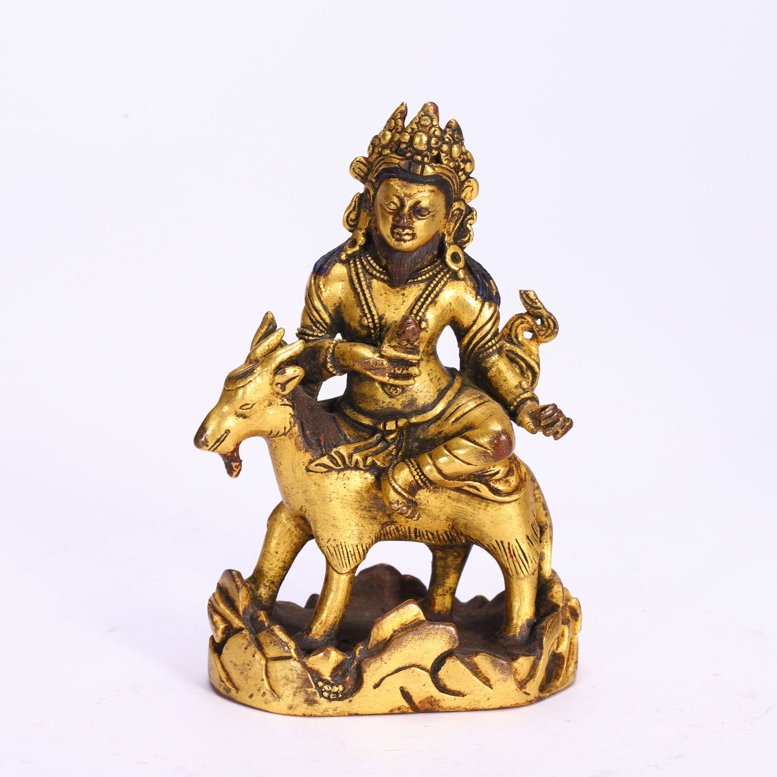 Bronze gilded statue of riding a sheep and protecting the law from the Ming Dynasty: Ming-Dynasty Gilt-Bronze Figure of a Goat-Riding Protector Deity. Imposing in presence and radiant with vitality, the piece stands 10 cm tall. The countenance is solemn and serene, the drapery flowing