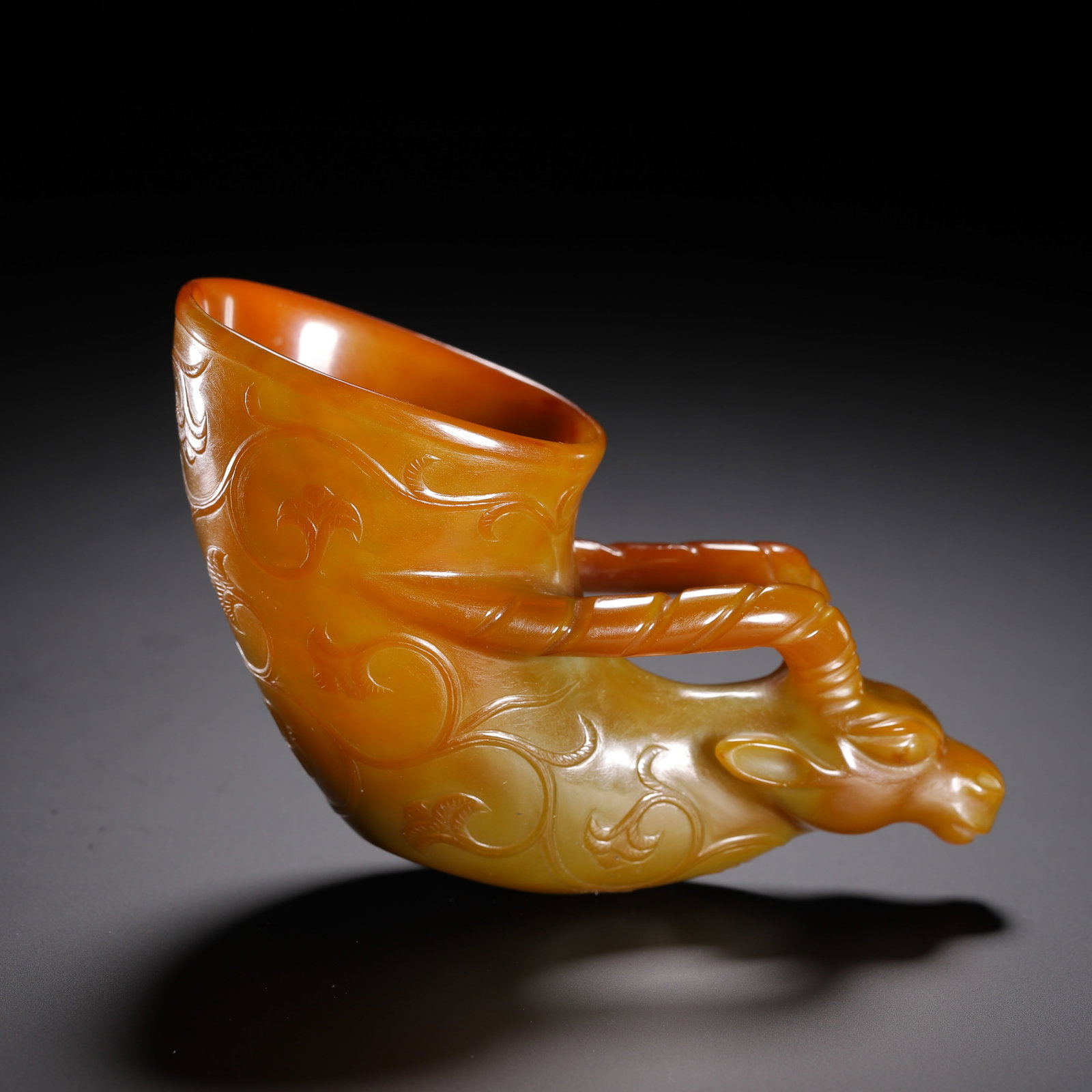 Qing Dynasty Agate Bull Head Cup: Qing-Dynasty Agate Ox-Headed Cup. Elegant and serene, with a naturally refined bearing, the piece stands 5.5 cm tall, and is 12 cm wide. The form is full, the glaze clear and elegant, the manufacture 