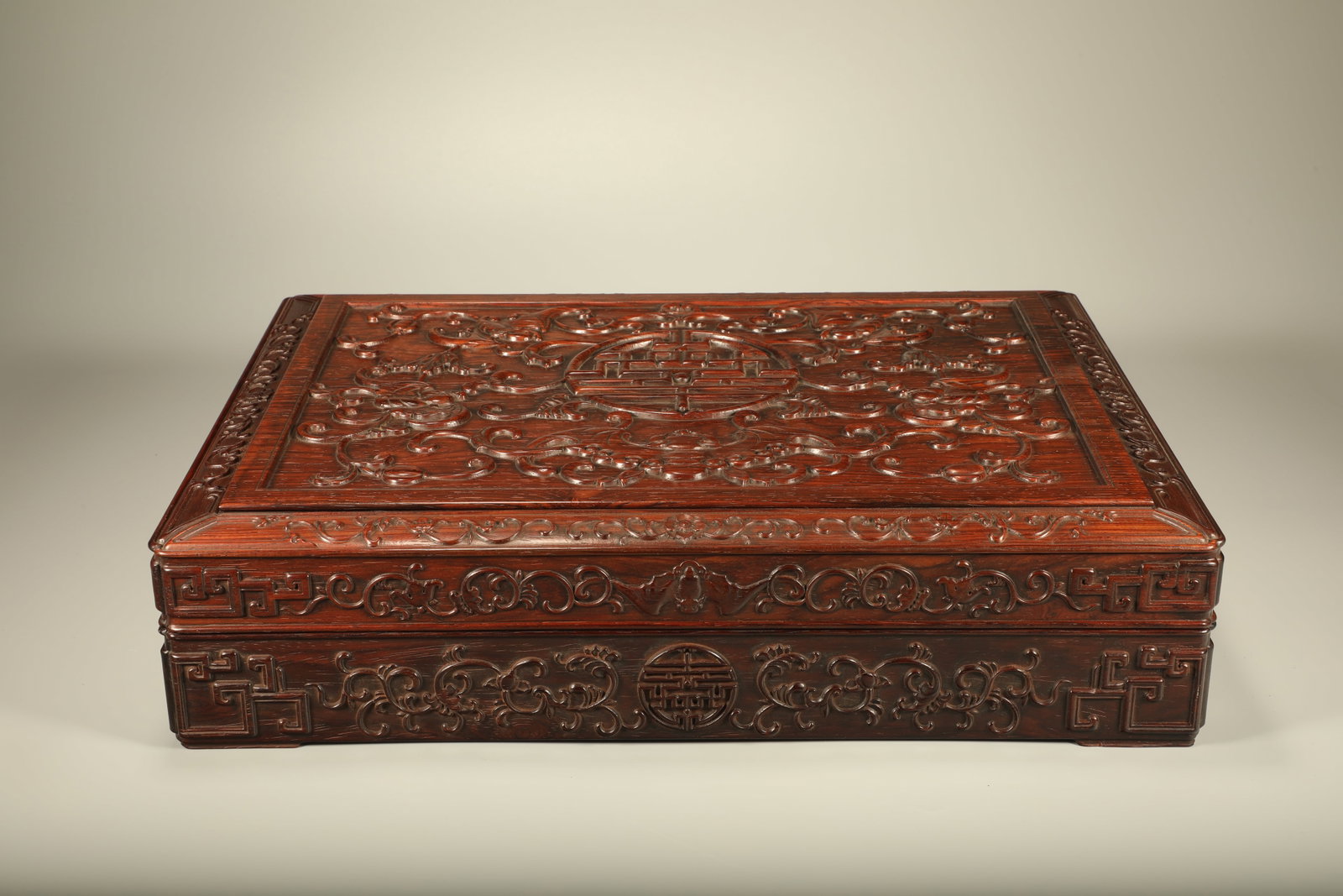 Qing Dynasty Huanghua Pear Carving Five Blessings Holding Longevity Box: Qing-Dynasty Huanghuali Box Carved with Five Bats and Longevity. Of superb material and workmanship alike, the piece measures 38.5 cm in length, is 28 cm wide, and stands 9 cm tall. The carving is ref