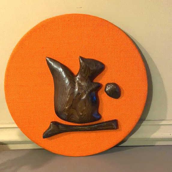 Robert Probert White Cedar Carved Squirrel On fabric covered cardboard. 14"diameter. Condition,: On fabric covered cardboard. 14"diameter. Condition, some scratches and scuffs to wood, some pulled threads