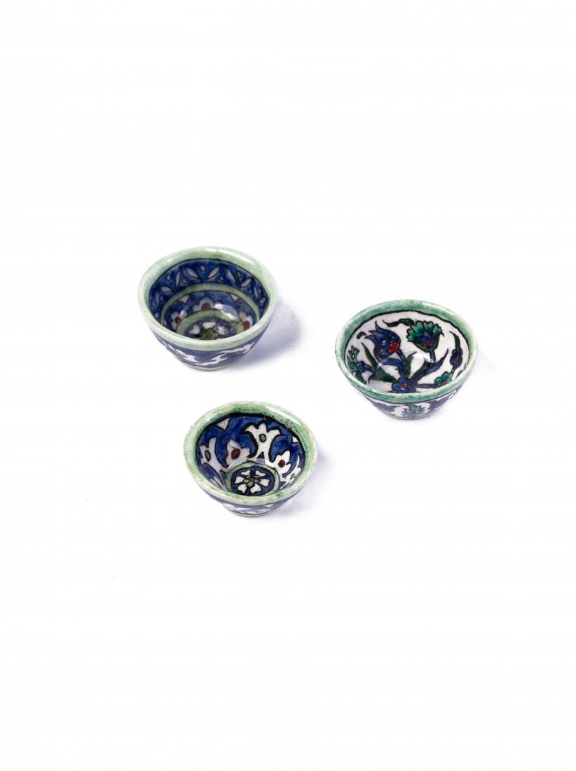 A vintage set of tiny and medium sized cups made of a: A vintage set of tiny and medium sized cups made of a porcelain