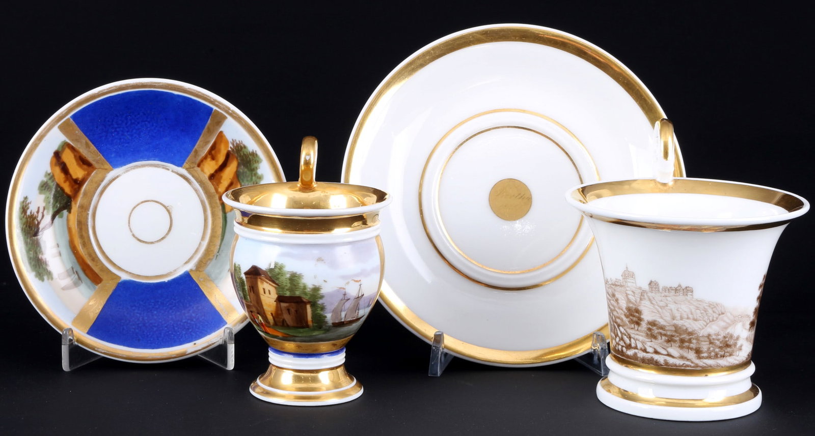 2 splendor view cups with landscape paintings from the 19th century - including France,: porcelain, without marks, decor landscape paintings and volute handles, one saucer inscribed Bertha 1826, 1x cup H 11.5 cm x D 10.5 cm, 1x saucer D 16.5 cm, 1x cup H 11 cm x D 7.5 cm, 1x saucer D 13.5