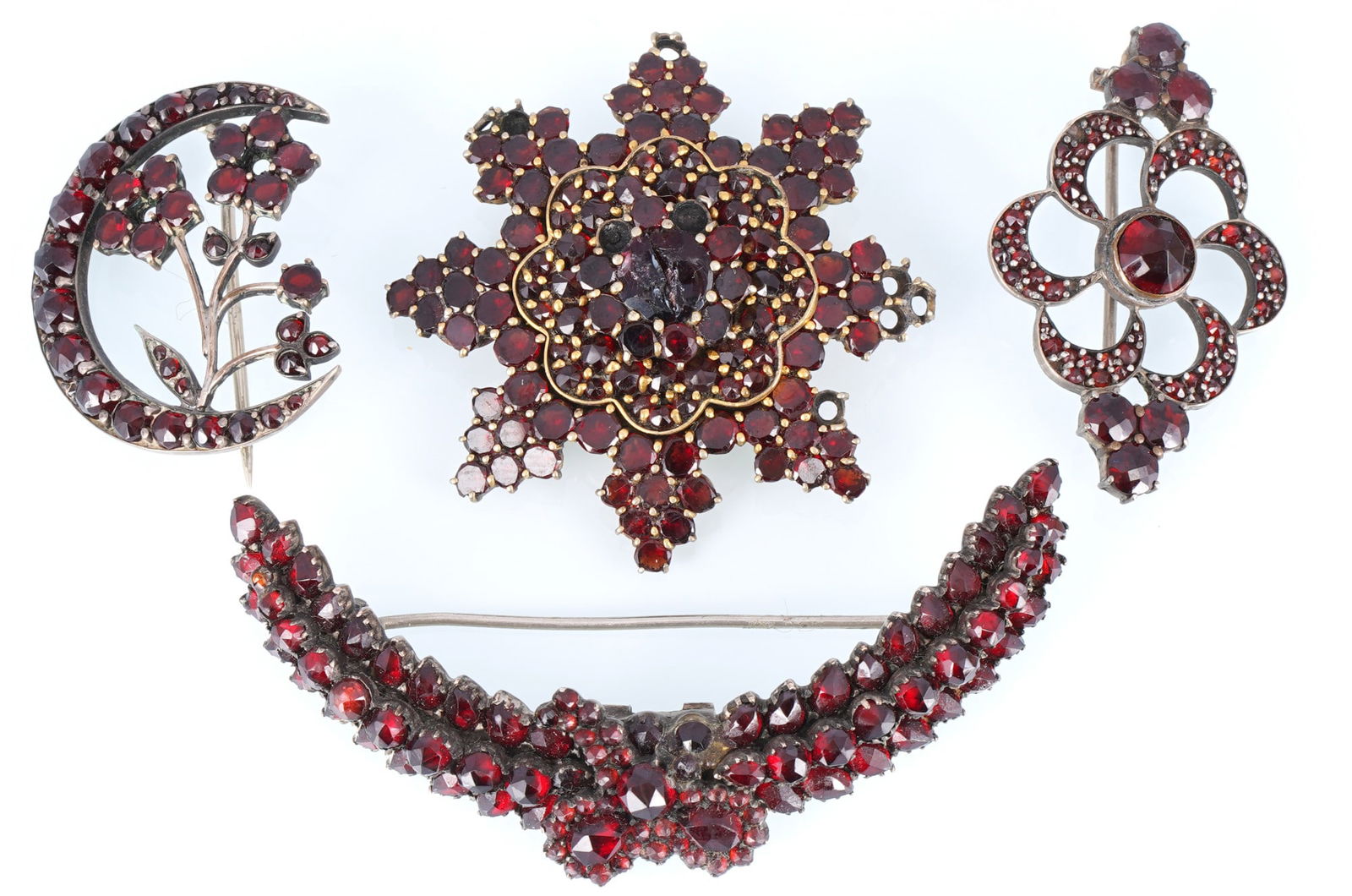 Garnet Jewelry Bohemian Garnet 4 Brooches: Four antique brooches with Bohemian garnets, including rose-cut and tombac-set pieces; brooch length 65 mm and smaller; total weight 29.8 g; signs of age and small missing garnets; restoration needed.