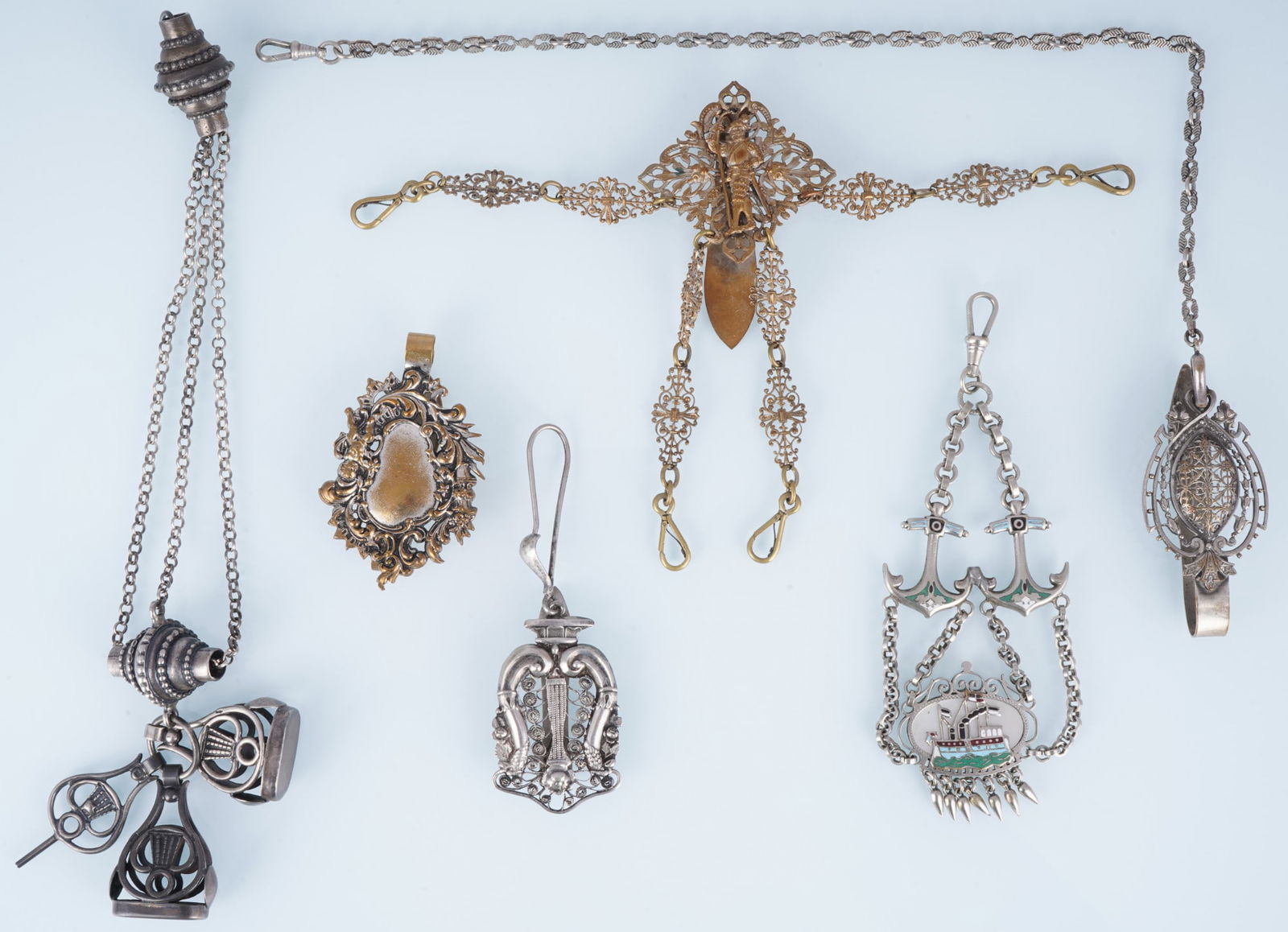 Watch jewelry - collection of chatelaines and pendants,: 19th/20th century, partly in silver (Dutch silver hallmark), gilded and silver-plated, diverse ensemble comprising a total of six finely crafted chatelaines and accessory pendants with engravings, ena