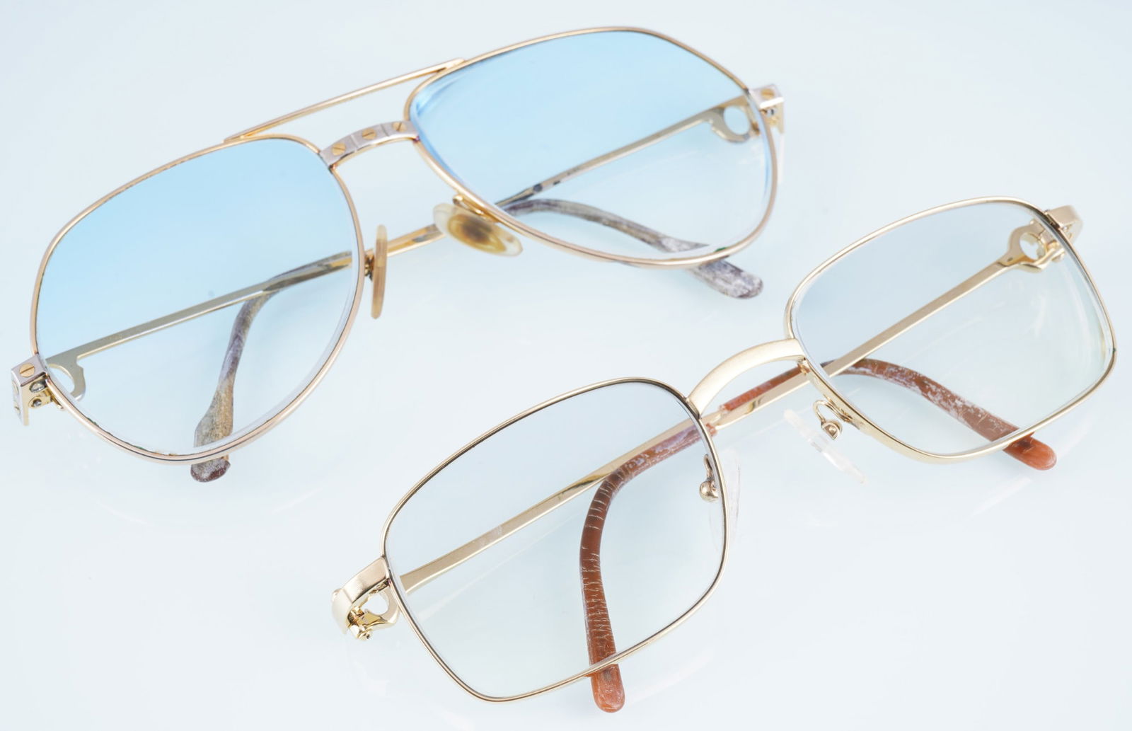 Cartier 2 Vintage eyeglass frames - incl. Romance Santos,: Full-rimmed glasses, 1x Romance Santos series, 18K gold-plated, serial number 157914, lens width 59 mm, bridge 16 mm, temples 140 mm (59-16-140), 1x 18K gold-plated, serial number 3045531, lens width