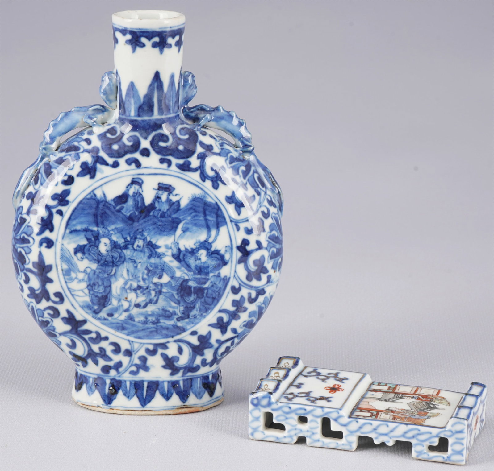 Two porcelain objects, China Qing Dynasty: Porcelain, China Qing Dynasty (1644–1911), a blue and white vase and a Famille Rose plate, H 15.8 cm x W 10.6 cm, H 8.4 cm x W 4.5 cm