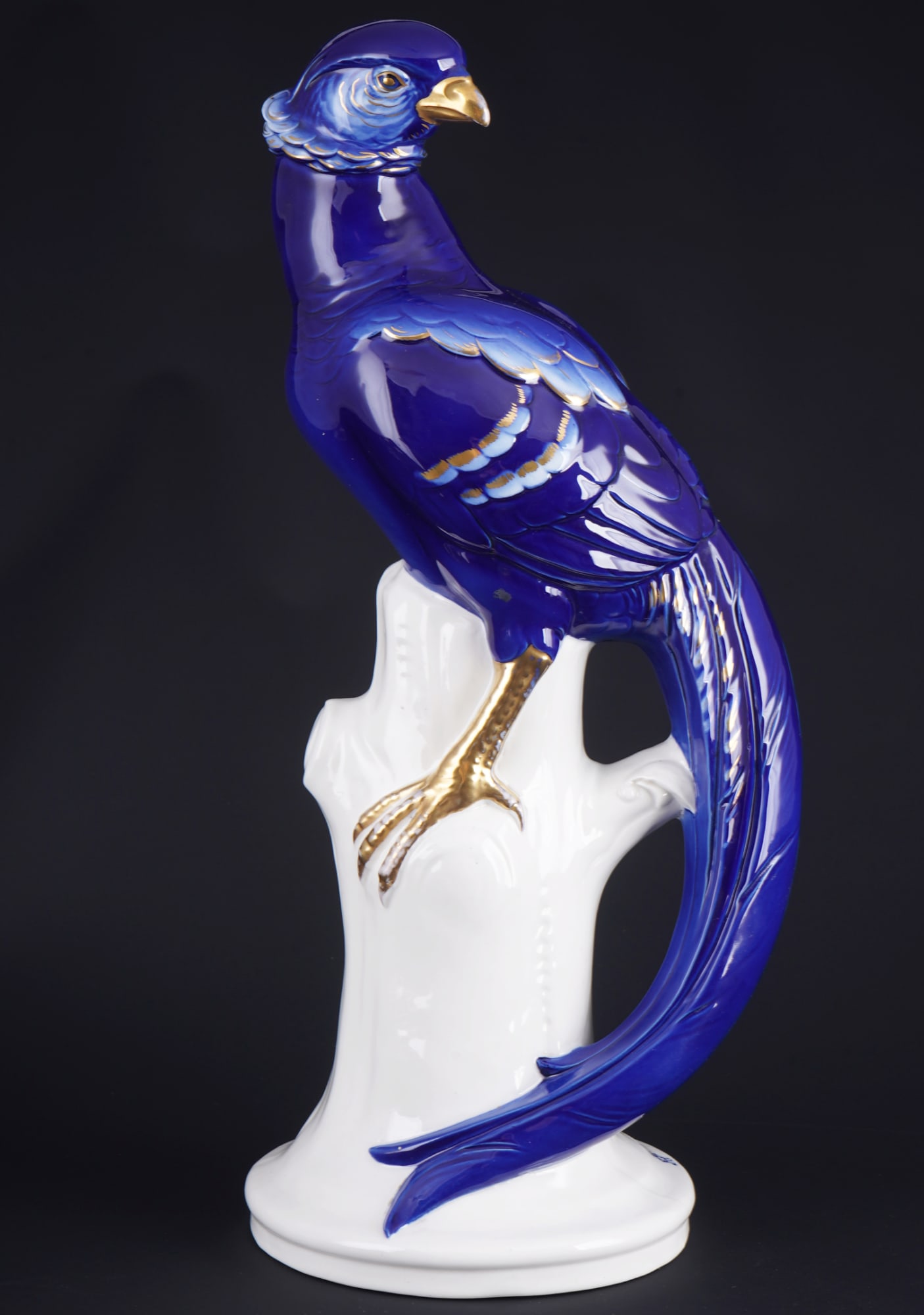 Volkstedt large Pheasant - Arthur Storch,: porcelain, blue company mark, designed by Arthur Storch (1870-1947), monogrammed AST on the base, royal blue pheasant on a tree stump, H 43 cm x W 19 cm x D 16 cm, glaze crack on the base