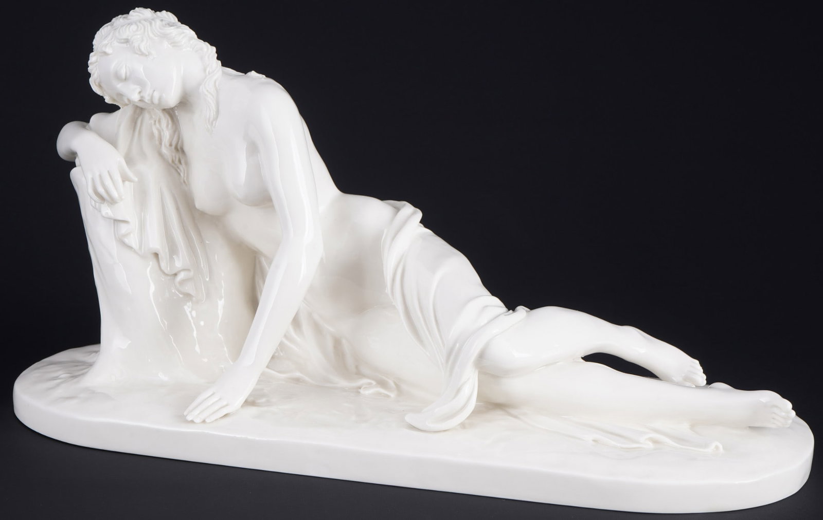 Nymphenburg resting nude - Roland von Bohr,: porcelain, green coat of arms mark, design by Roland VON BOHR (1899-1982), reclining figure - partial nude of a young beauty, model no. 853, H 17.5 cm x L 34.5 cm x W 12.5 cm