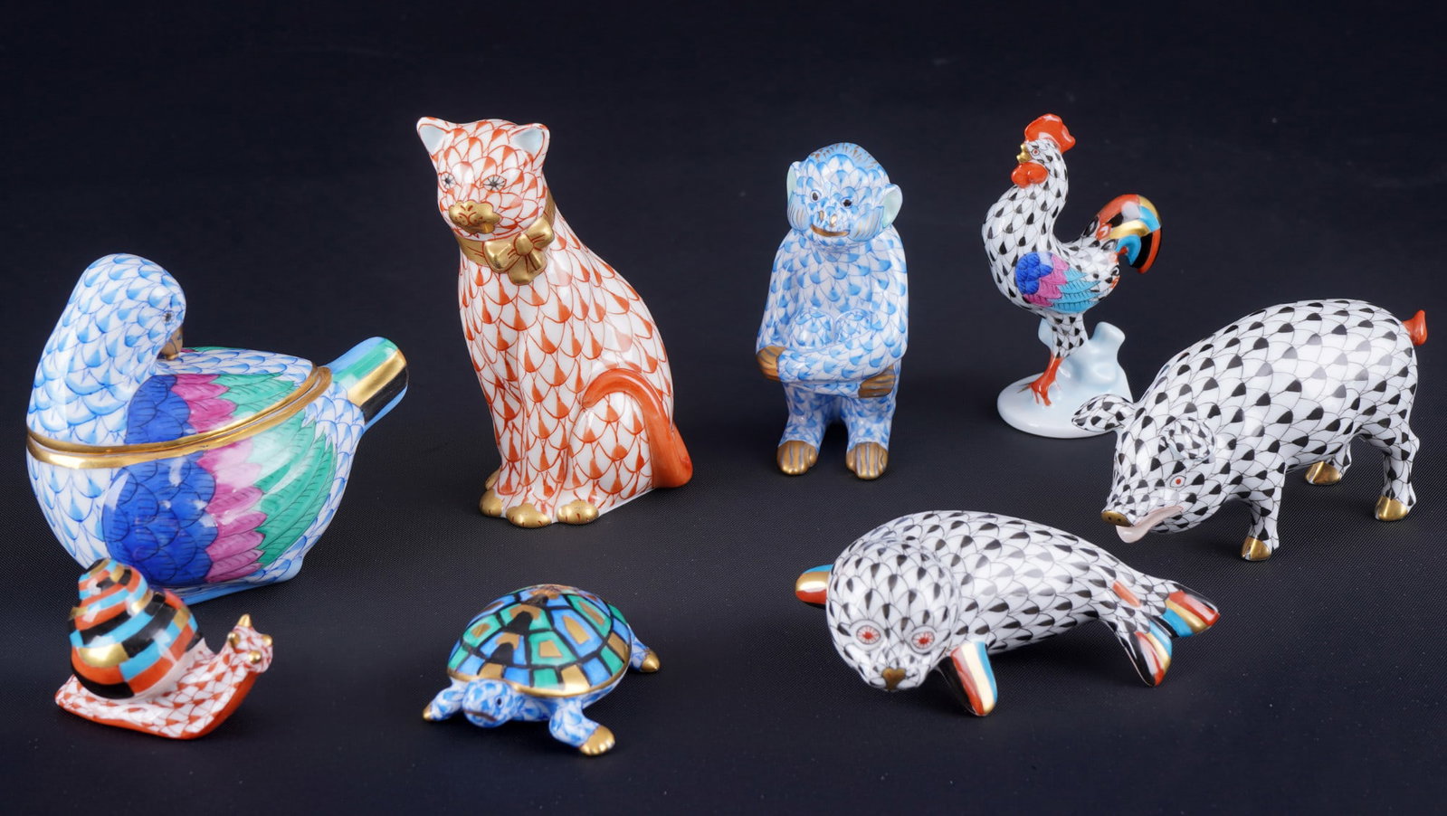 Herend Vieux Fishnet 8 animal figures - in three colours,: porcelain, Hungary 20th century, blue company mark, decor VH / VHB / VHN Vieux Herend - Fishnet, in the colors black, blue and red, 1x cat #15536 8.5 cm x W 5 cm, 1x snail #15518 H 3 cm x L 4.5 cm, 1x