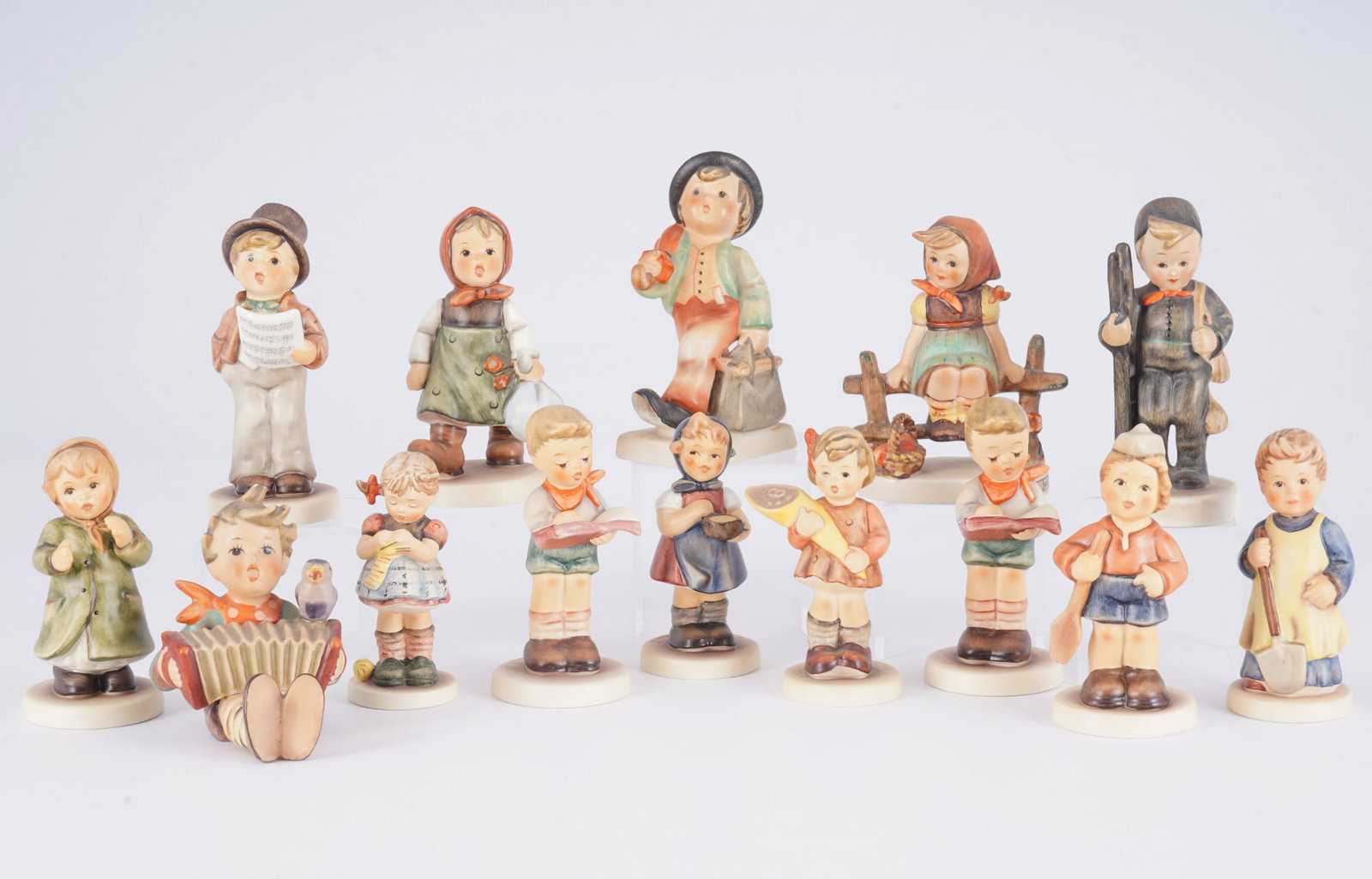 Hummel / Goebel 14 children,: porcelain, blue company mark, design after Maria Innocentia HUMMEL (1909-1946), with signature, various children's figures including a wandering boy and a running girl, 14 x H 8.5 - 10.5 cm