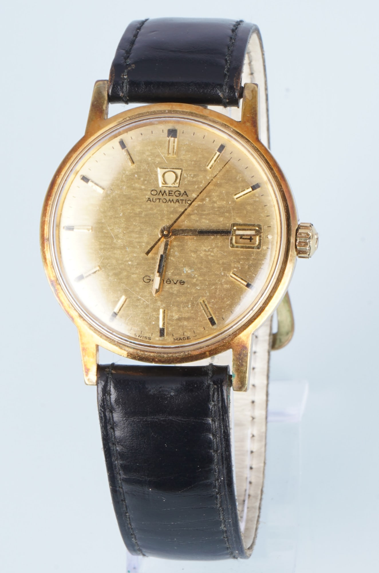 Omega Geneve Automatic Men's Wristwatch: Gold-plated stainless steel, a classic from the 1970s, automatic movement, Ref. 166.070, mosaic dial, leather strap with pin buckle, H 41 mm x V with crown 37 mm, weight 44 grams, working condition, m