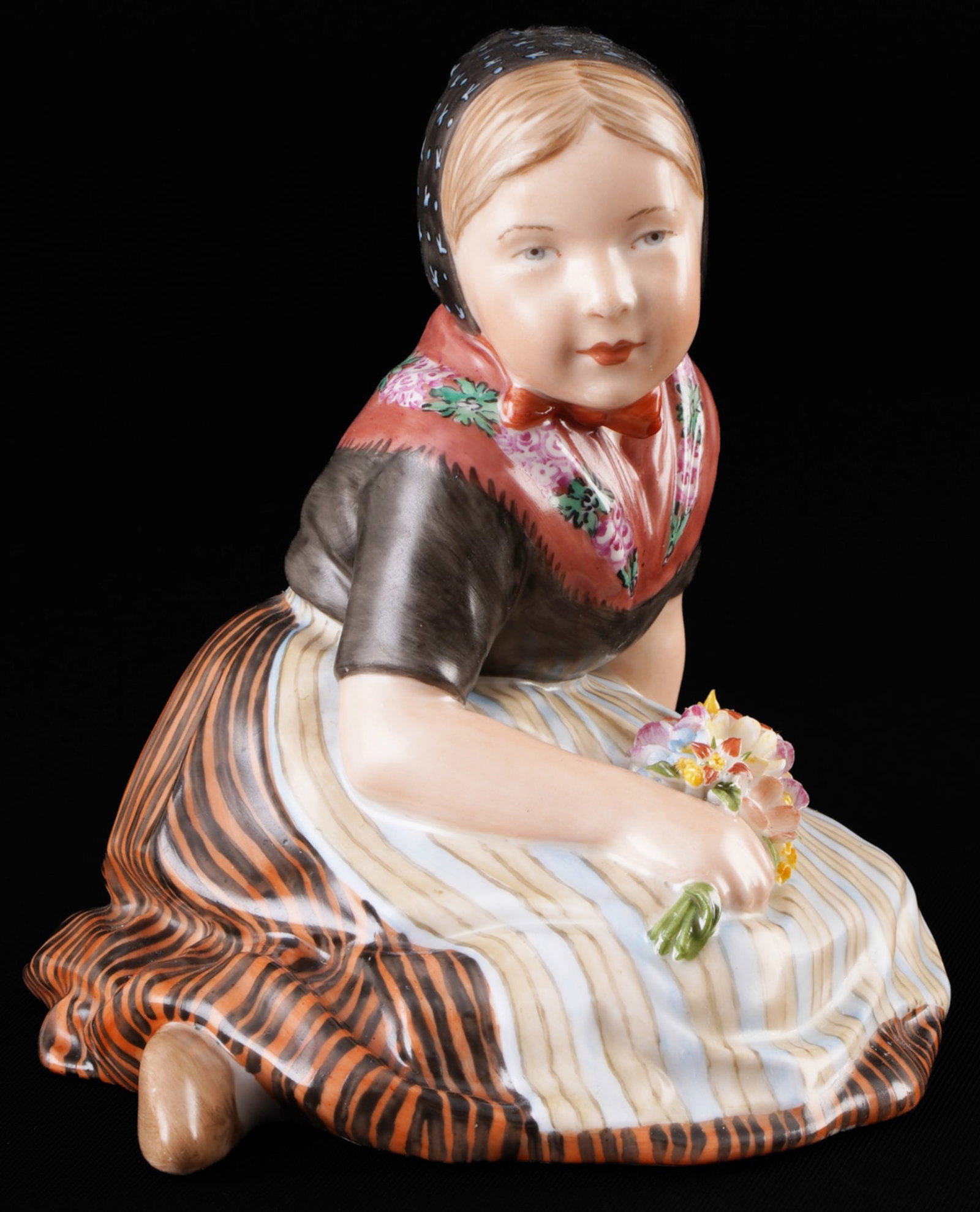 Royal Copenhagen girl from Faroe in traditional costume ? C. MARTIN-HANSEN,: porcelain, Denmark, with green crown mark and blue waves, design by Carl MARTIN-HANSEN (1877-1941), girl from the Faroe Islands with flowers, series of children in Danish national costumes, model no. 