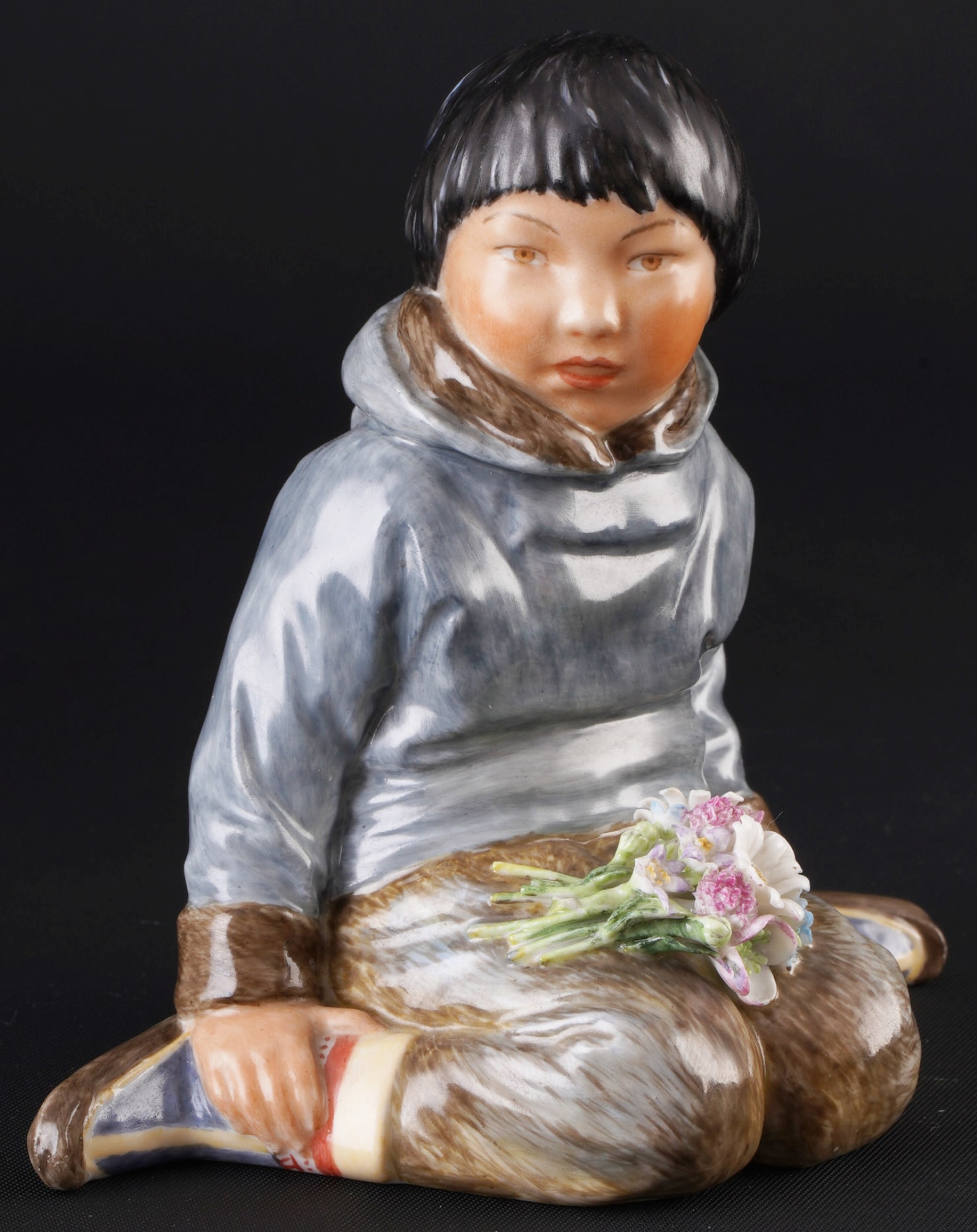 Royal Copenhagen boy from Greenland in traditional costume ? C. MARTIN-HANSEN,: porcelain, Denmark, with green crown mark and blue waves, design by Carl MARTIN-HANSEN (1877-1941), boy from Greenland with bouquet of flowers, series of children in Danish national costumes, model no