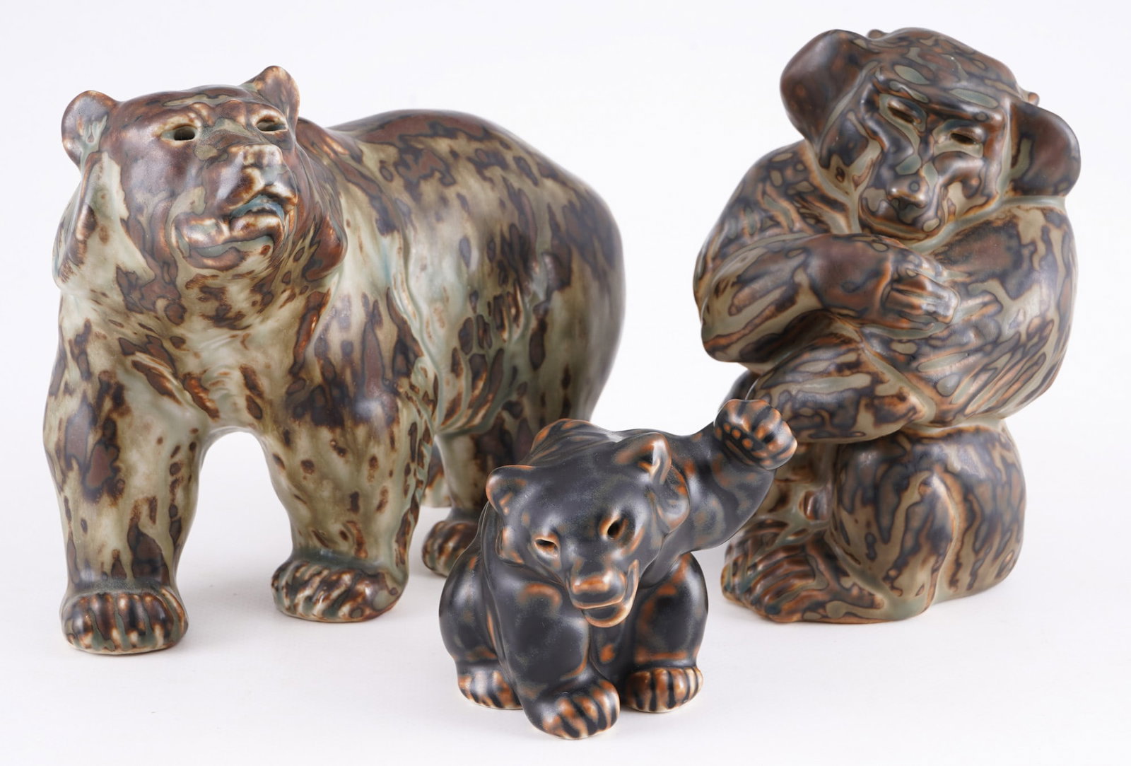 Royal Copenhagen 2 bears with baboon - Knud KYHN,: earthenware/ceramic, Denmark, with green company mark and blue waves, designed by Knud KYHN (1880-1969), 1x bear #20155 H 13.5 cm x W 18.5 cm x D 9.5 cm, 1x small bear #21433 H 7.5 cm x W 7 cm x D 9 c