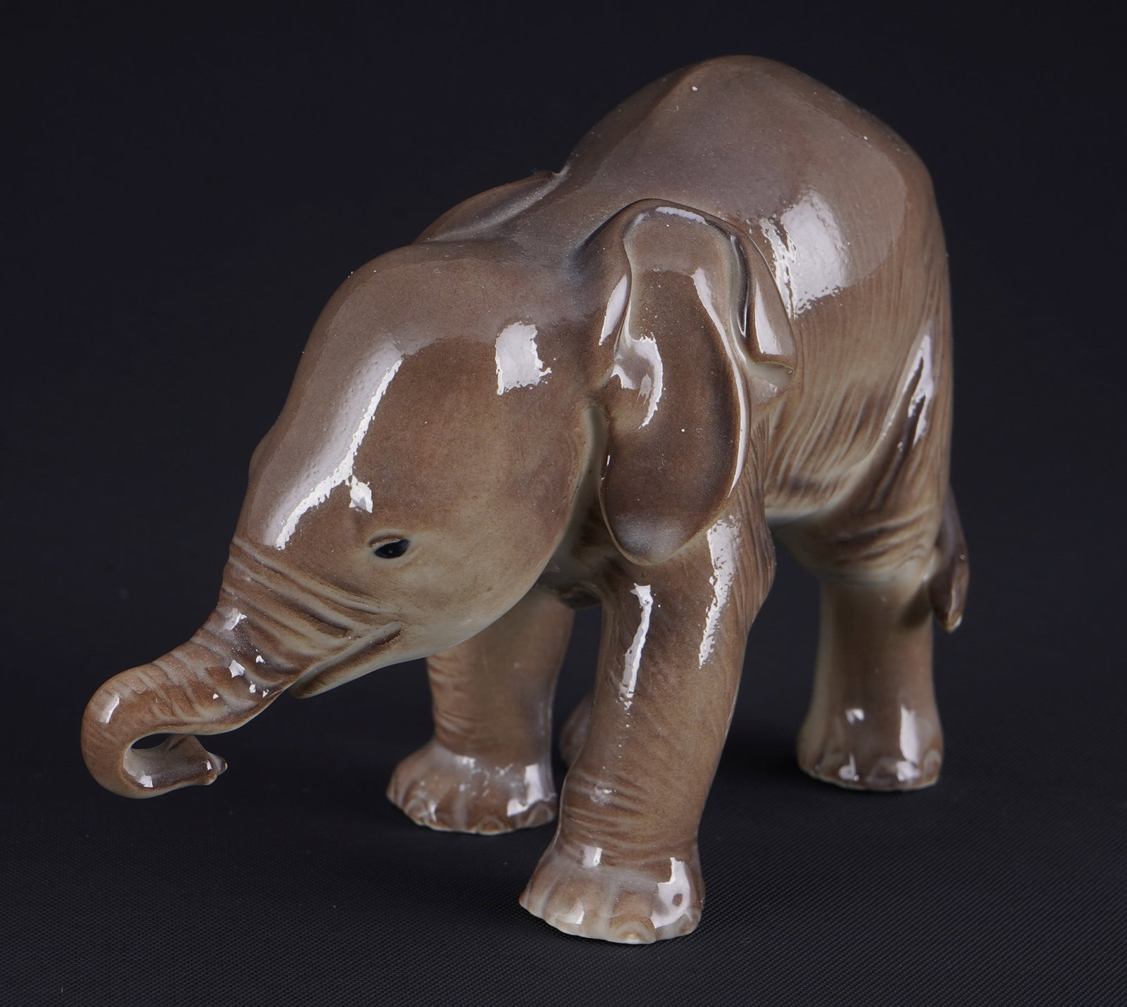 Allach elephant calf - Th. KaeRNER,: porcelain, green SS Allach company mark 1935?1945, design by Theodor KaeRNER (1884-1966), young elephant, colored, model no. 3, H 7 cm x L 10 cm x W 4 cm