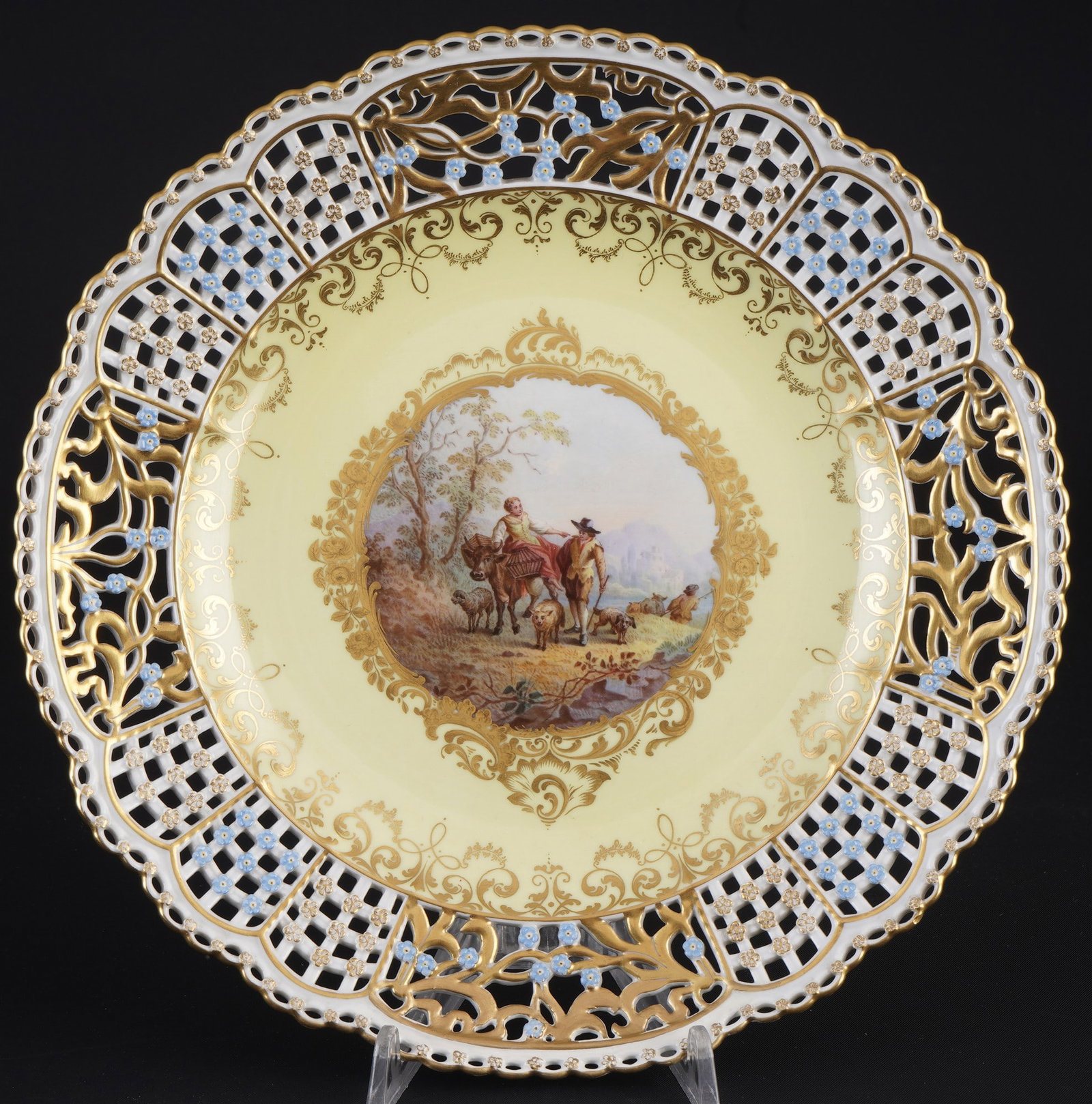 Meissen cutwork splendid plate with pastoral scenery and yellow ground 1st choice - after: porcelain, blue sword mark 1st choice, knob mark 1860-1924, decor: pastoral cattle scene ? a peasant woman riding on a cow with a carrying basket, accompanied by a shepherd with a staff, sheep and dog