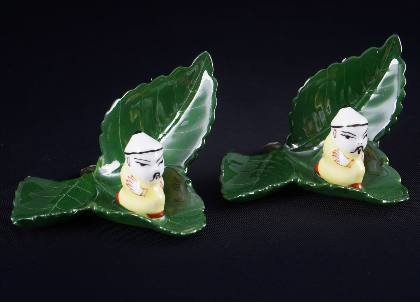 Herend Chinoiserie 2 table card holders 6477,: porcelain, Hungary 20th century, blue company mark, decor Chinoiserie decor - figurative place card holders - chinese figure on leaf, model no. 6477, 2x H 4.5 cm x W 7.5 cm x D 7 cm