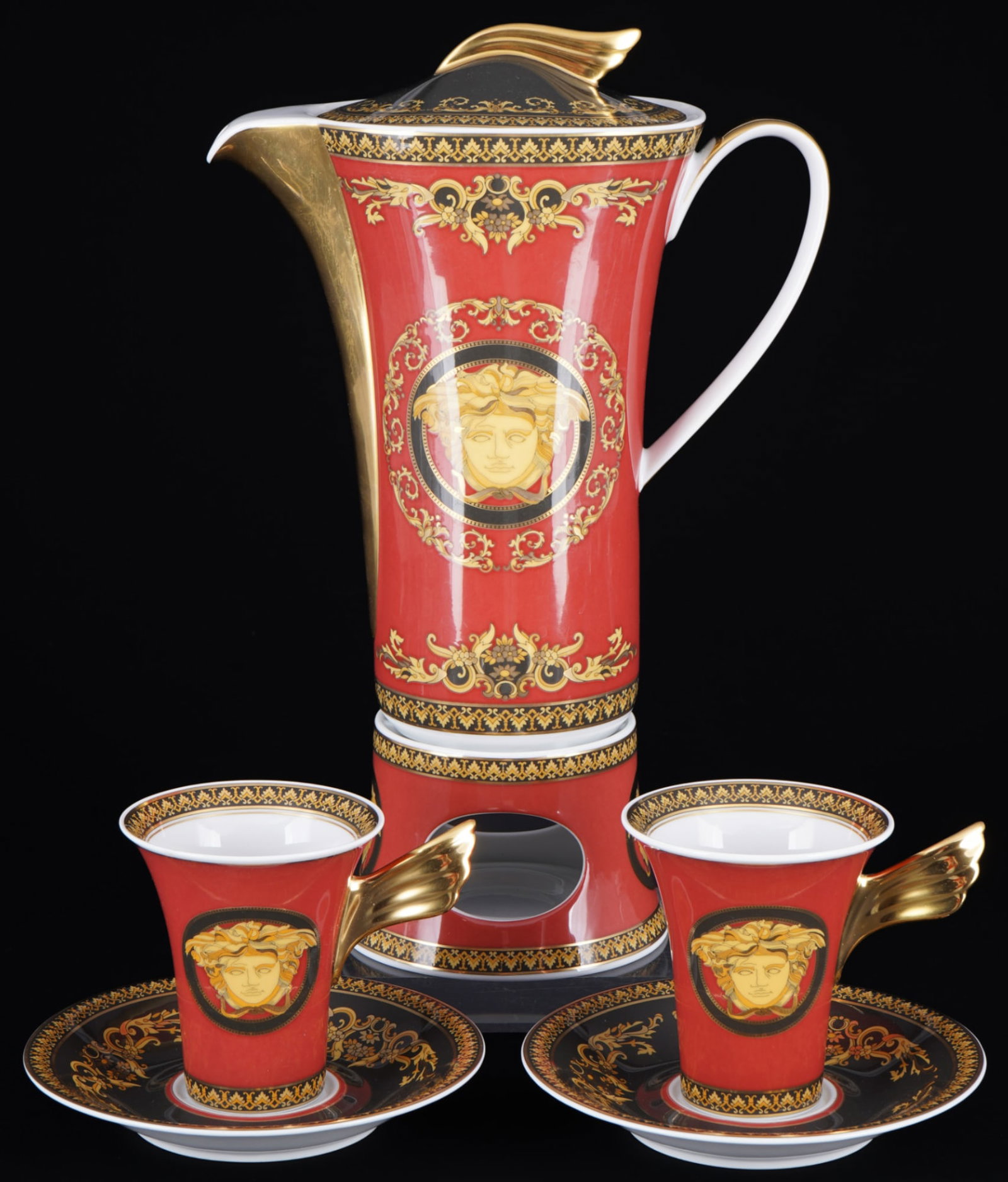 Rosenthal Versace Medusa coffee pot on warmer with 2 coffee cups,: 6-piece porcelain, black and gold company mark, decor Versace Medusa, shape Icarus, design by Paul WUNDERLICH (1927-2010), 1x coffee pot H 23.5 cm x W 10 cm x D 21 cm, 2x coffee cups H 9 cm x D 8 cm, 
