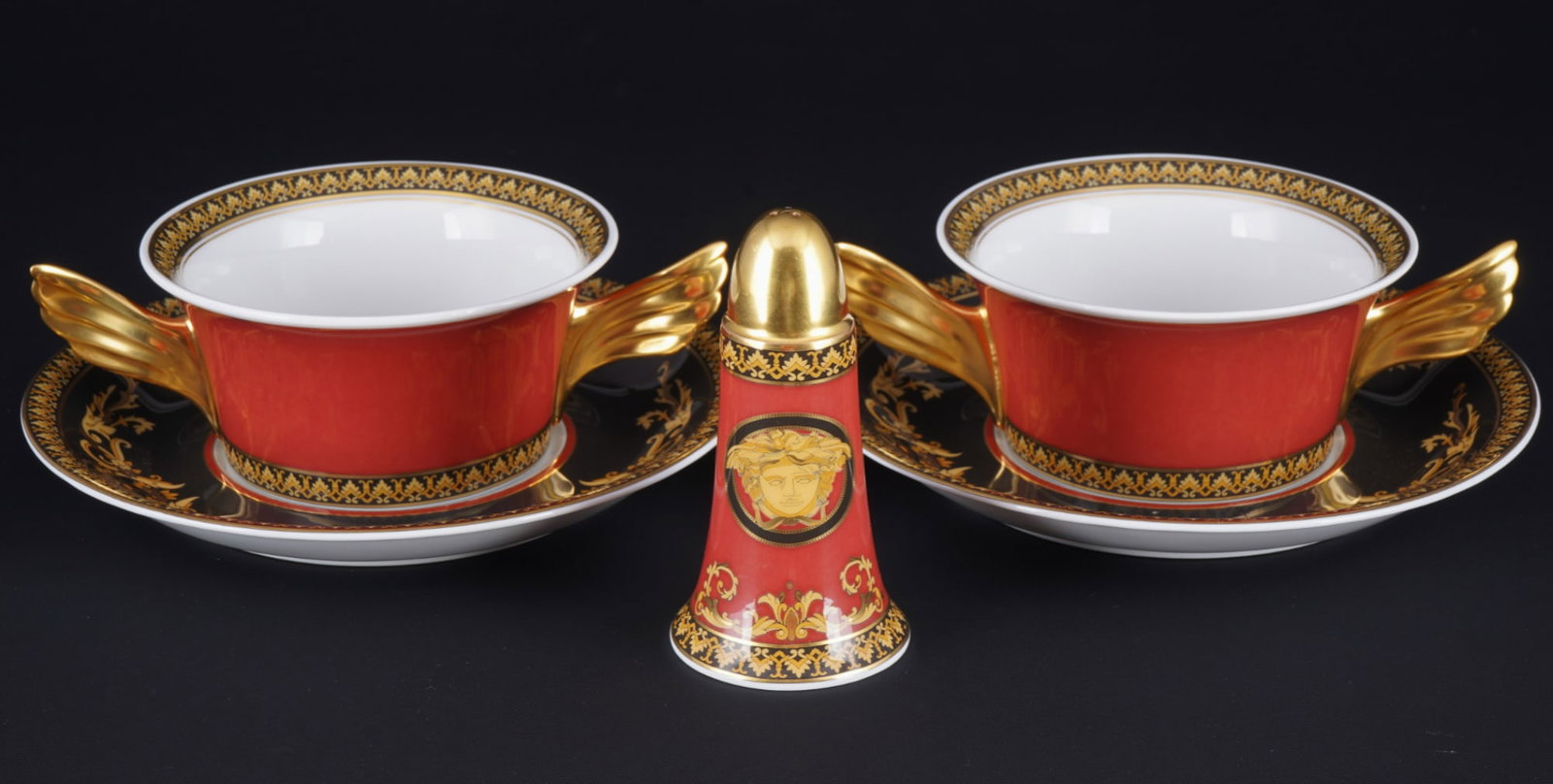 Rosenthal Versace Medusa 2 soup bowls with shaker,: 5-piece porcelain, black and gold company mark, decor Versace Medusa, shape Icarus, design by Paul WUNDERLICH (1927-2010), 2x soup bowls H 5.5 cm x D 11.5 cm, 2x saucers D 17.5 cm, 1x salt shaker H 10