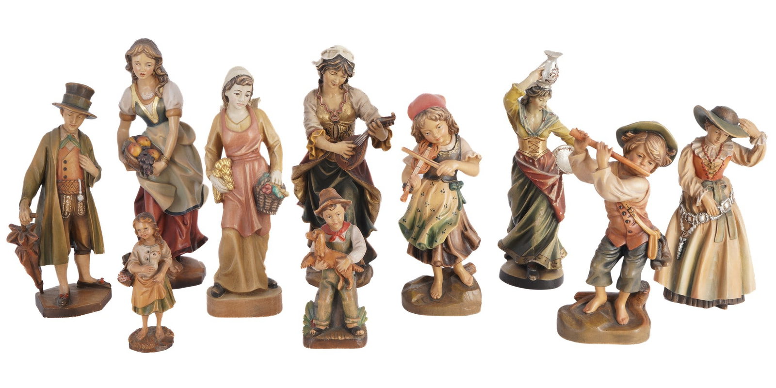 10 carved wooden figures, including Anri,: Hand-carved and polychrome painted, various peasant and Alpine genre scenes, including musicians, market women and children, some with manufacturer's labels e.g. Anri, H 29.5 cm x W 12 cm and smaller