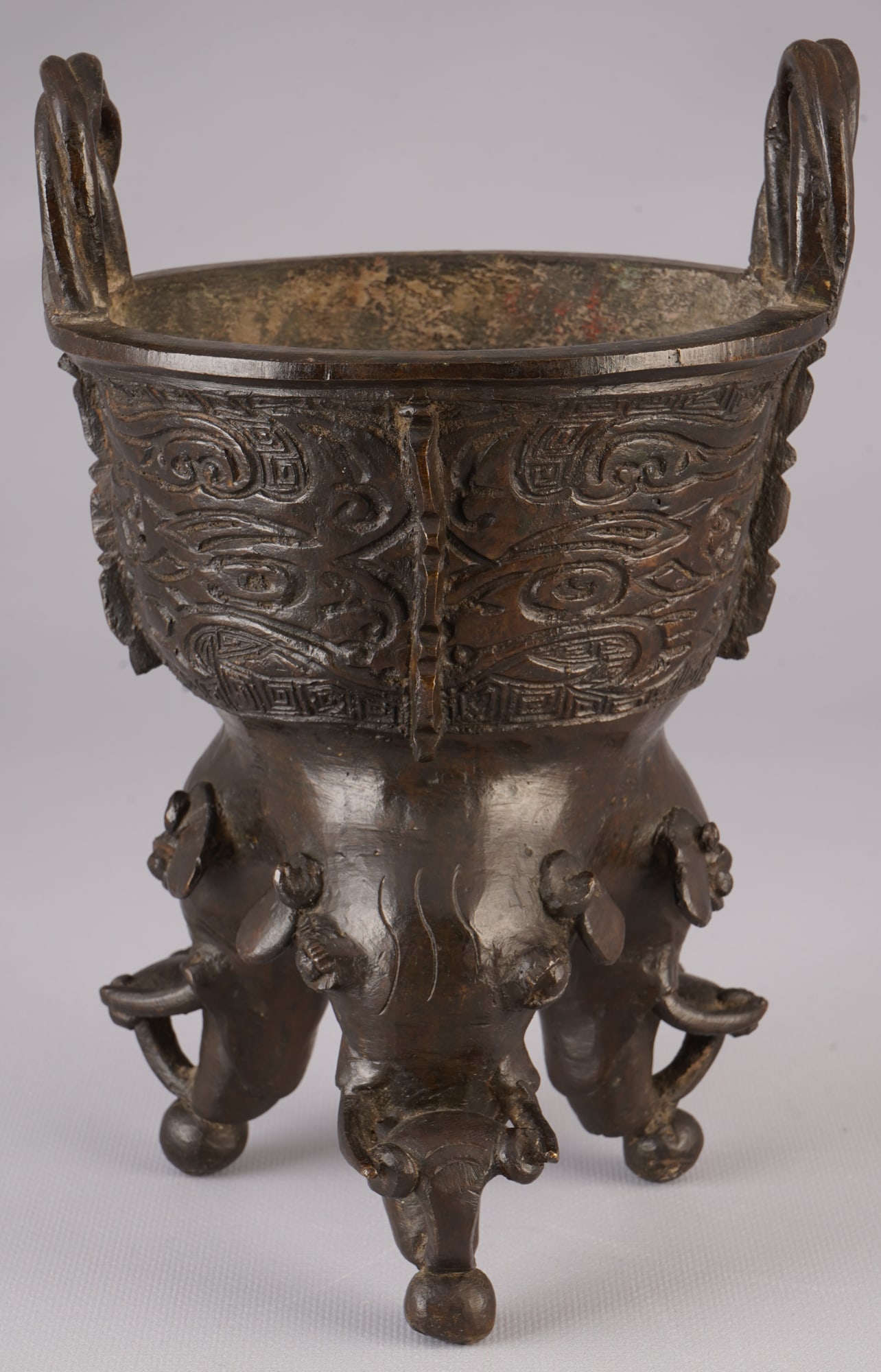 Bronze incense burner with Chenghua seal mark, China, Qing Dynasty: Bronze, China, Qing Dynasty (1644–1911), an exceptional three-legged incense burner in the form of a ding (three-footed kettle) in an archaic style, the surface is decorated with deeply reliefed, au
