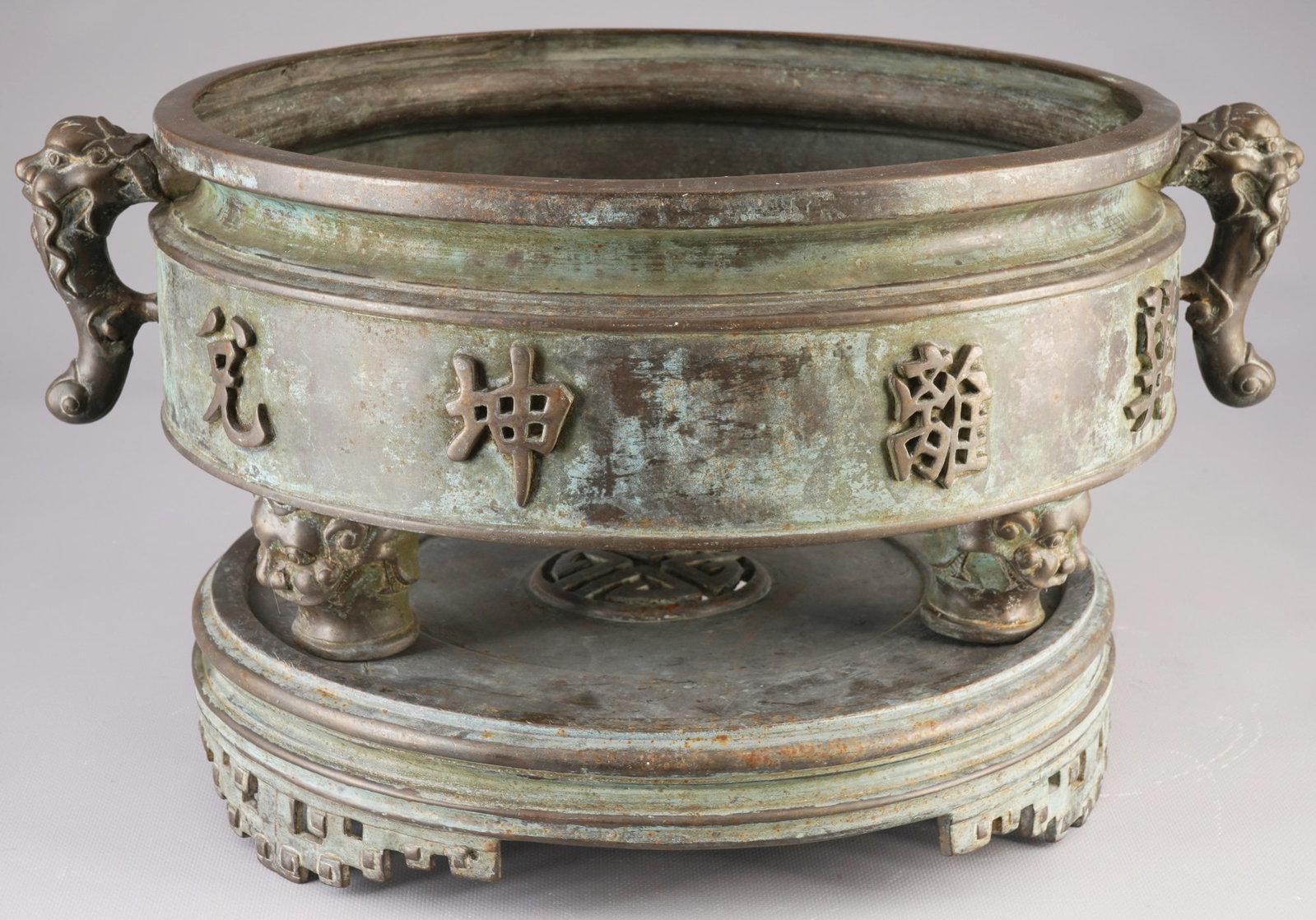 Large bronze tripod bagua incense burner, China, Qing Dynasty: Bronze, China, Qing Dynasty (1644–1911), large tripod Bagua incense burner (ding) in archaic style, with two animal-head handles and three sturdy legs, the main feature is the continuous casting of