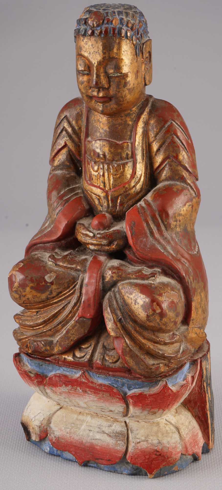 Seated Buddha Shakyamuni, China, 19th/20th century: Wood, China, 19th/20th century, gilded wooden sculpture of the seated Buddha Shakyamuni, H 23.2 cm x W 10.7 cm x D 7.5 cm, with flaking, signs of age, German private collection