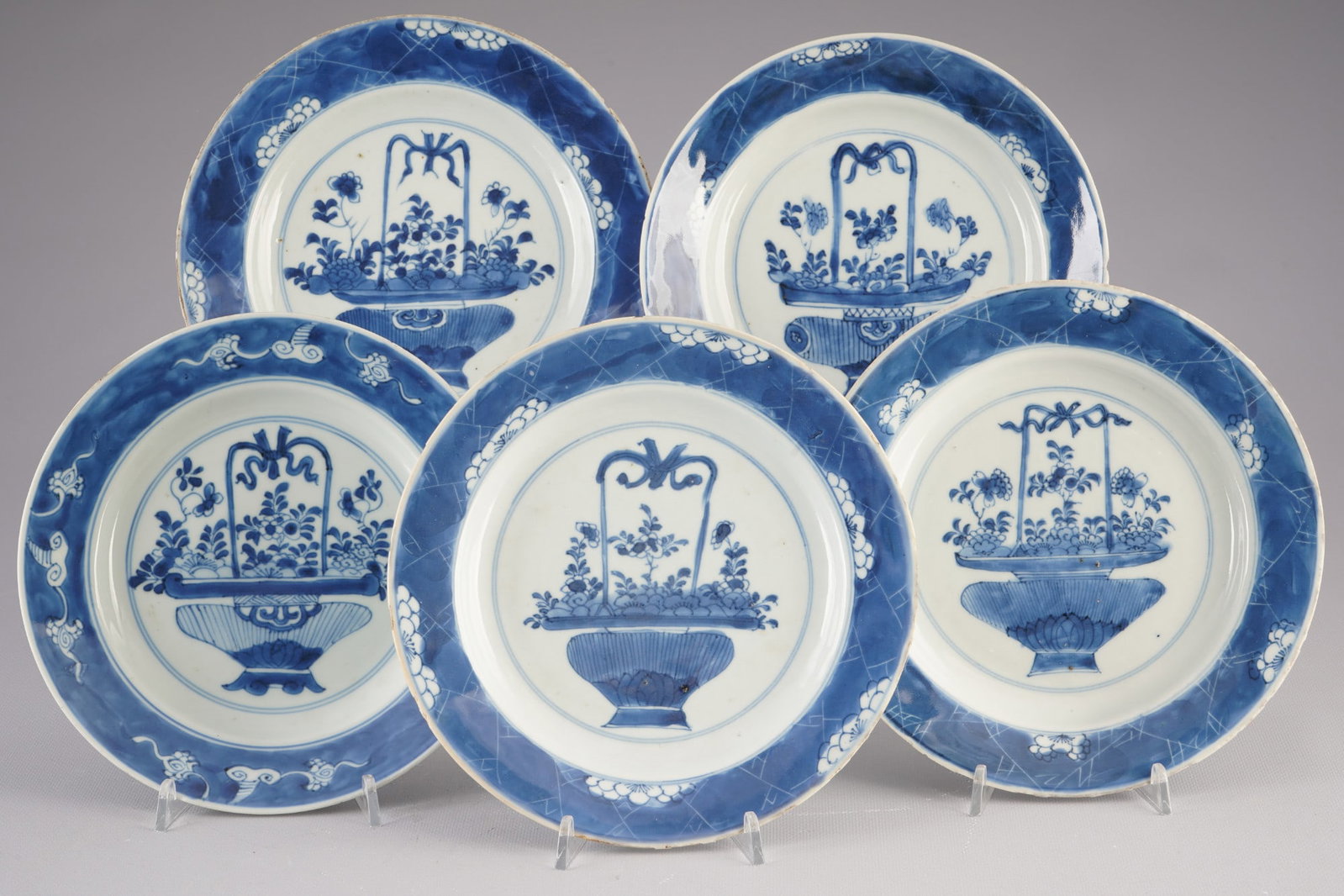 Five blue and white plates, China, Qing Dynasty, Kangxi/Yongzheng period,: Porcelain, China, Qing Dynasty, Kangxi/Yongzheng period (1662–1735), five blue and white plates decorated with a floral motif, various underglaze blue base marks, diameters 22 cm – 21 cm, chips on