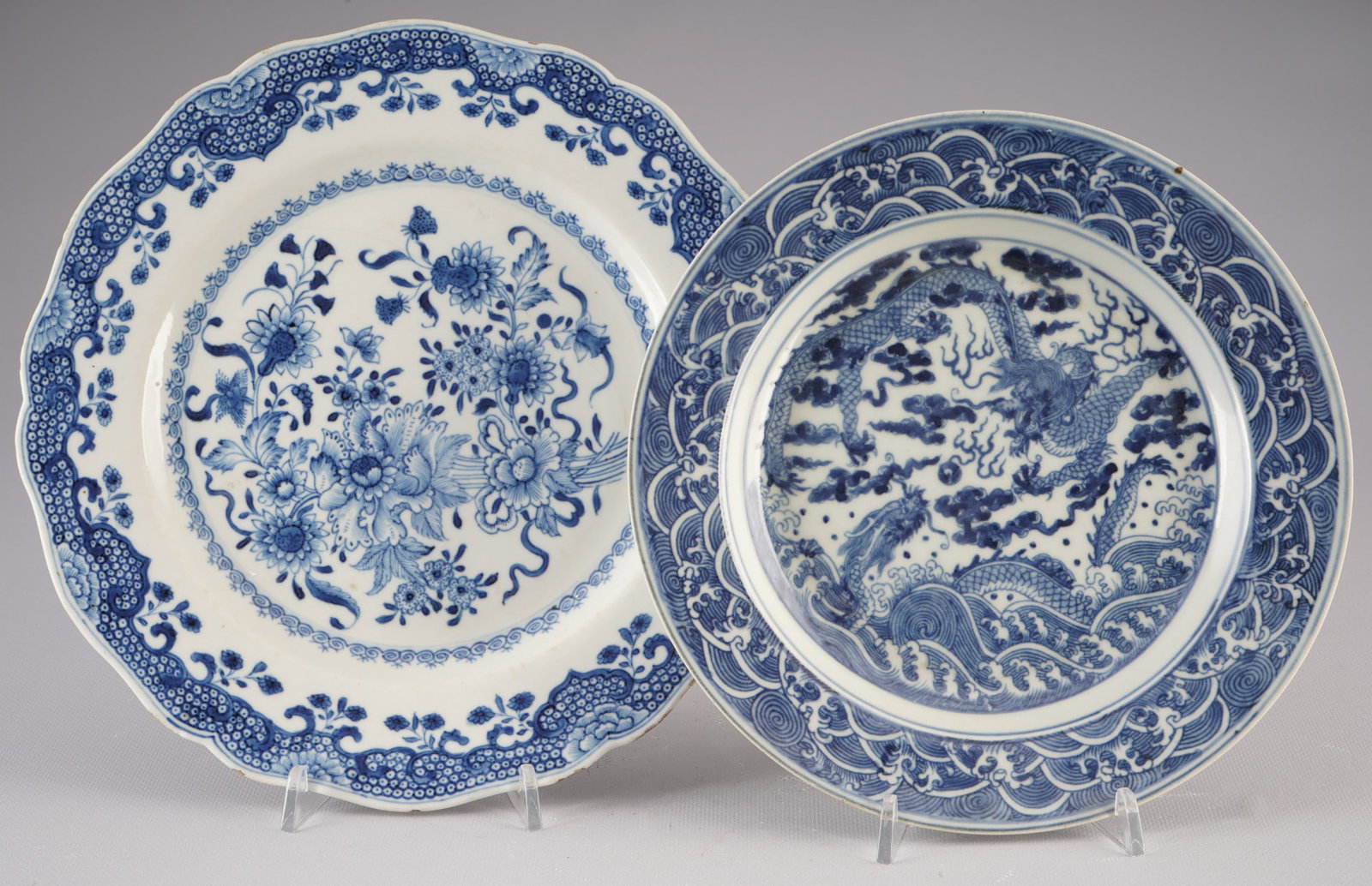 Pair of blue and white plates, China, Qing Dynasty: Porcelain, China, Qing Dynasty (1644–1911), a pair of plates with blue and white painting, decorated with dragons and flowers, D 23.6 cm, D 23 cm, one plate with a crack and chip