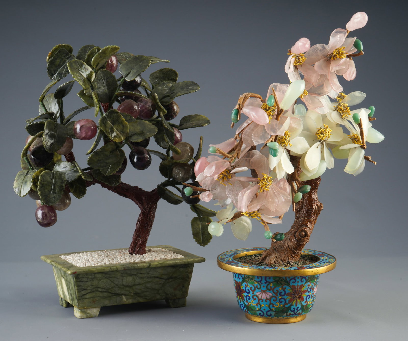 2 sculptures, China, 20th century,: Jade, soapstone and cloisonné, China, 20th century; Grapes H 35.5 cm × W 29 cm × D 12.5 cm; Magnolia H 39 cm × W 23 cm × D 20 cm; small crack