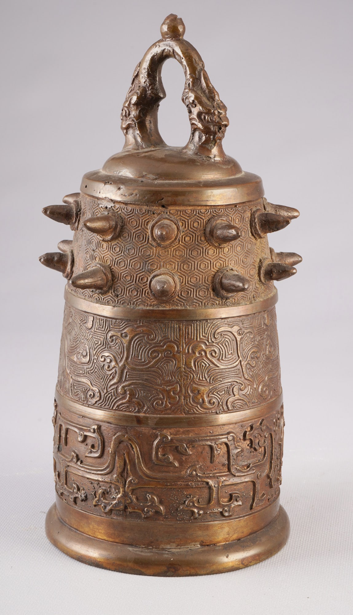 Archaic bronze bell, China, Qing Dynasty: Bronze, China, Qing Dynasty, 18th century, a ritual bell modeled after an antique design, with a domed body and a flat striking ring. The dragon on the lid serves as a suspension loop. The entire surf