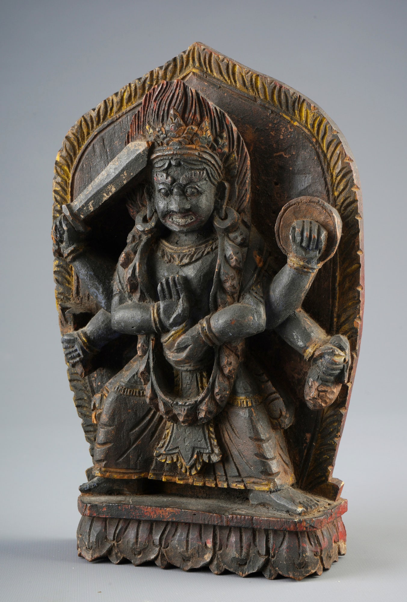 Wood-carved protective Dharma god, China/Tibet;: Wood, China/Tibet, wood with high-relief carving and colored painting of a Dharma god, H 26 cm × W 16 cm × D 5 cm