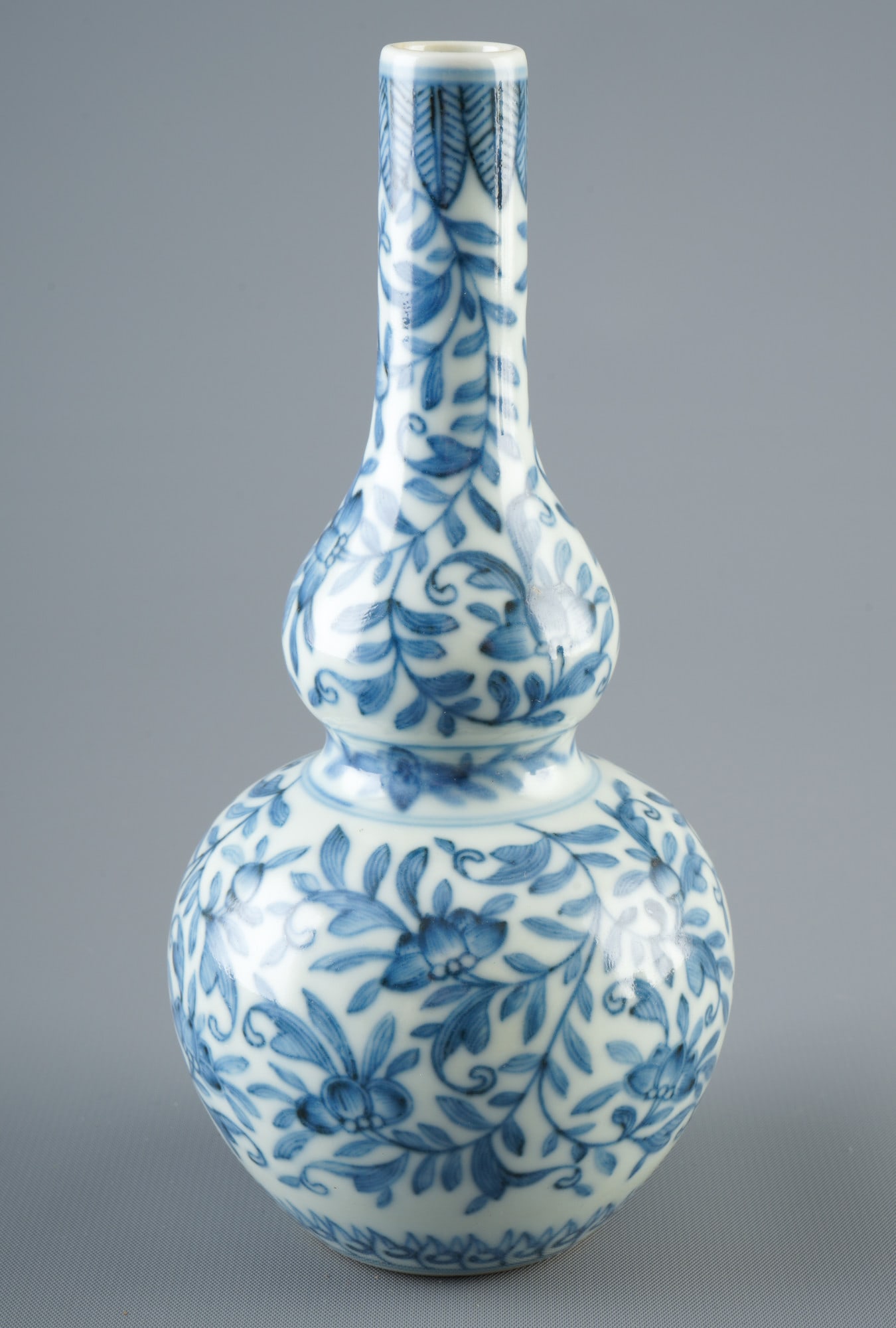 Blue and white gourd vase, China, late Qing Dynasty: Porcelain, China, late Qing Dynasty (1840–1911), blue and white gourd vase with tendril flowers, stylized lotus leaves on the base, double circle and leaf/knot flower seal mark on the bottom, H 17 c