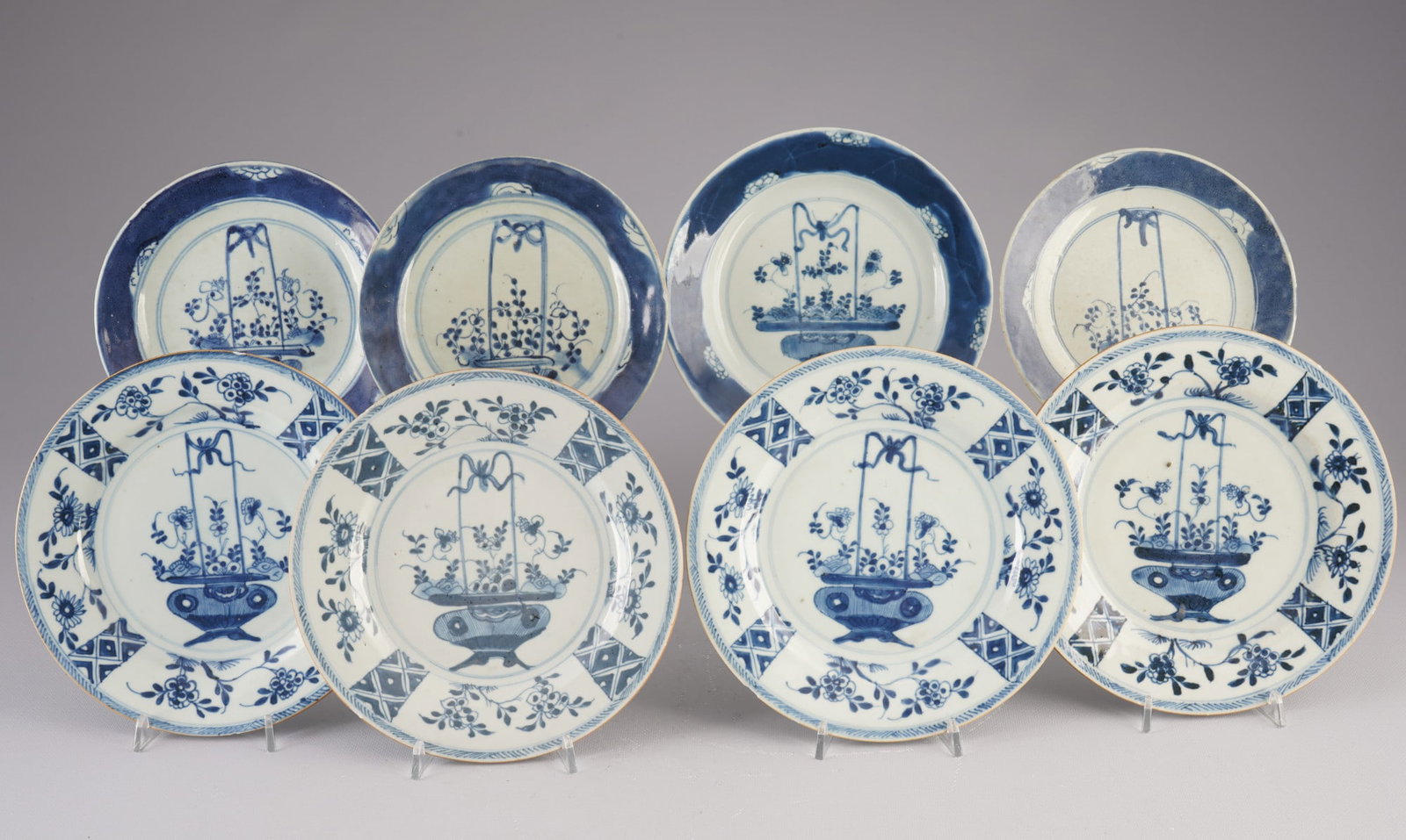 Eight blue and white plates, China, Qing Dynasty,: Porcelain, China, Qing Dynasty (1644–1911), eight blue and white plates with floral decoration, diameters 22.8 cm – 19 cm, chips on the rim, three plates with cracks