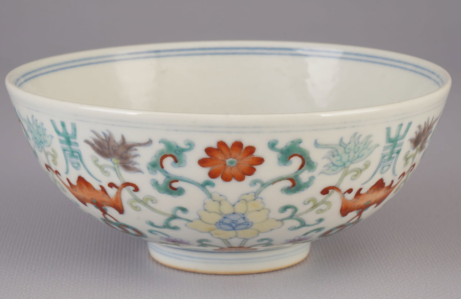 Famille rose bowl with fushou, China, Jiaqing period,: Porcelain, China, Qing Dynasty, Jiaqing period (1796–1820), a deep, slightly flared famille rose bowl with fu and shou surrounding the longevity symbol, blue 6-character Jiaqing seal mark, H 6.4 cm 