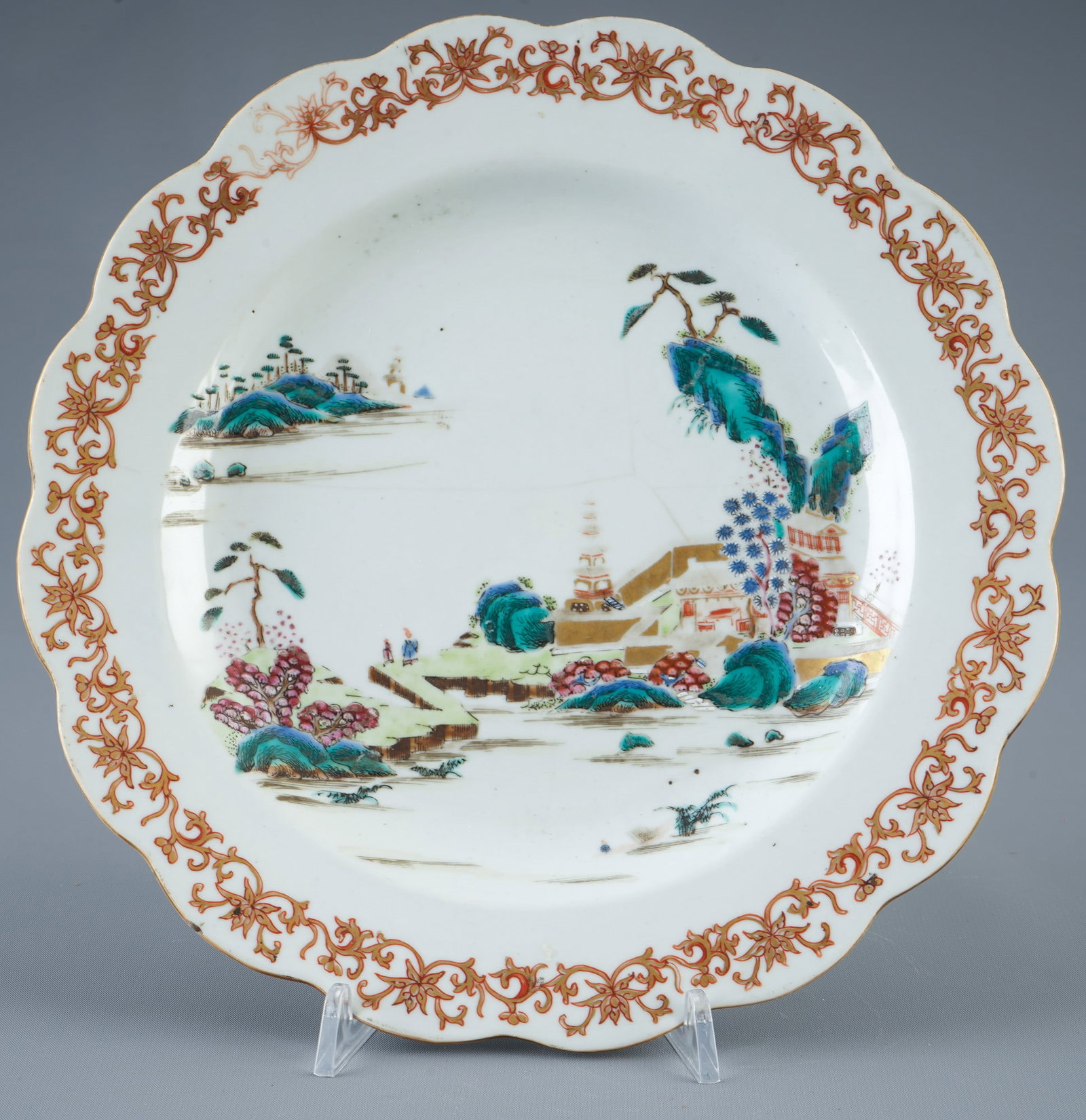 Famille Rose plate with landscape, China, Qianlong period,: Porcelain, China, Qing Dynasty, Qianlong period (1735–1796), finely painted plate with wavy rim and gold tendril decoration, in the center a landscape scene with pavilion, pagoda, rock formations an
