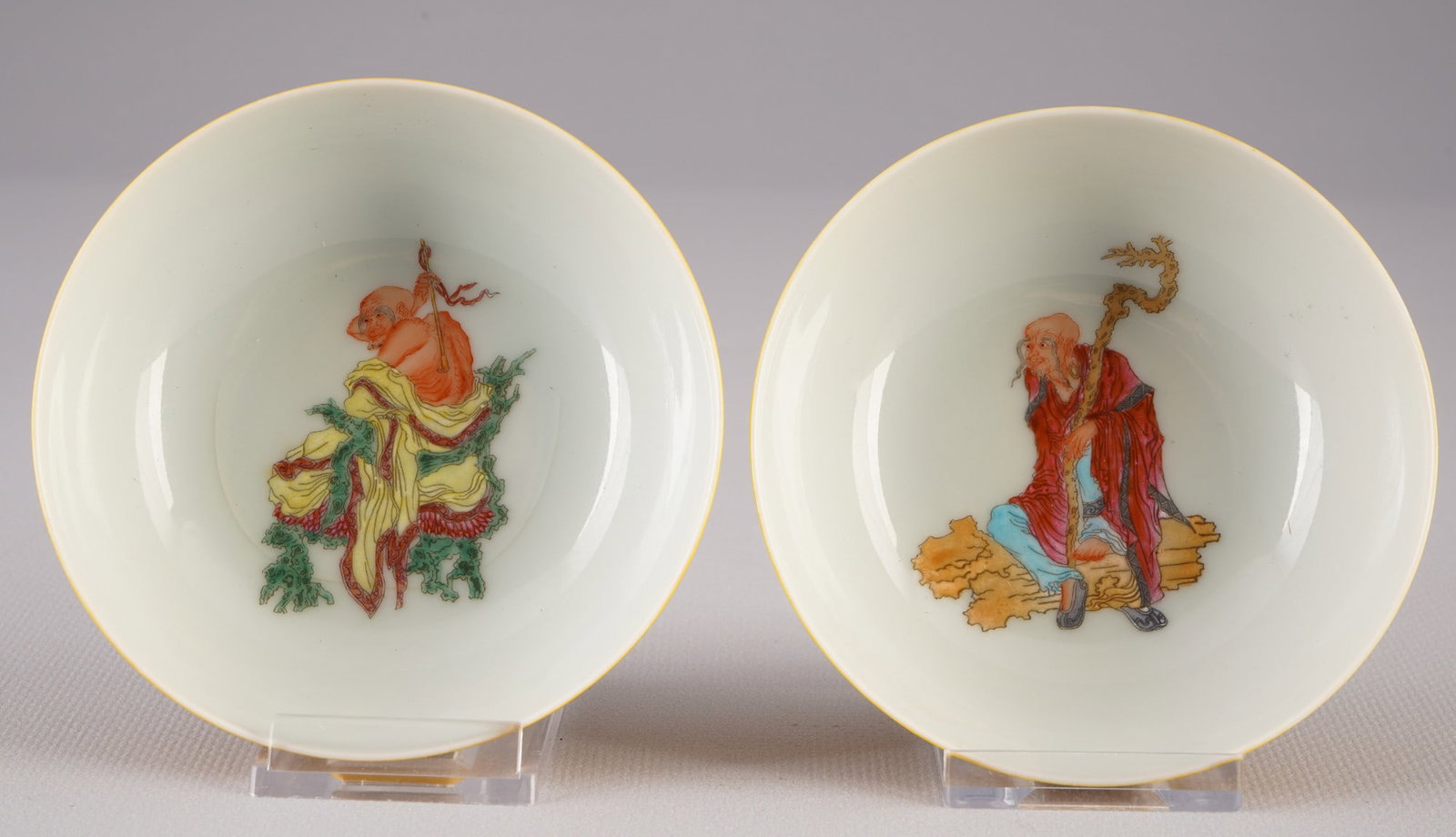Pair of Famille Rose bowls, China,: Porcelain, China, a pair of Famille Rose bowls, painted with figures (Arhat/Luohan), blue Qianlong mark, 2 x H 3.3 cm x D 9.7 cm, one bowl with a slight crack