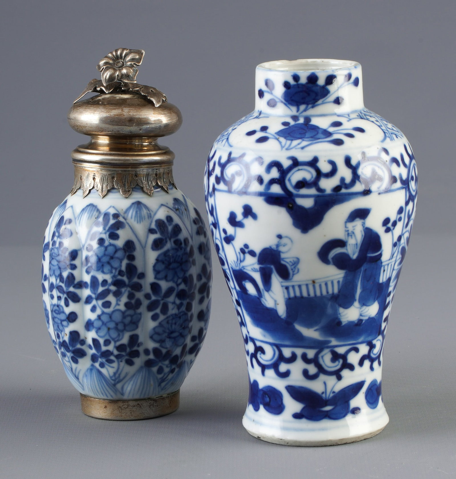 Two small blue and white vases, China, Qing Dynasty,: Porcelain, China, Qing Dynasty (1644–1911), two small blue and white vases, one with a silver lid and foot, H 13.2 cm × D 7.5 cm, H 13.5 cm × D 6.3 cm, one vase with a small chip on the rim