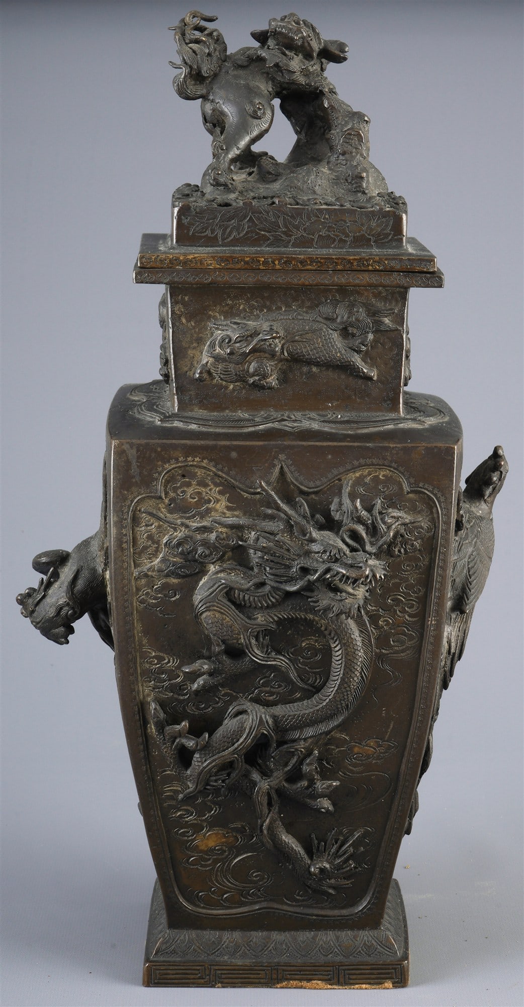 Large bronze lidded vase with high relief, Japan, Meiji period.: Bronze, Japan, Meiji period (1868–1912), lidded vase with high relief of dragon, phoenix and lion, H. 40 cm × W. 20.3 cm × D. 18 cm, signs of age