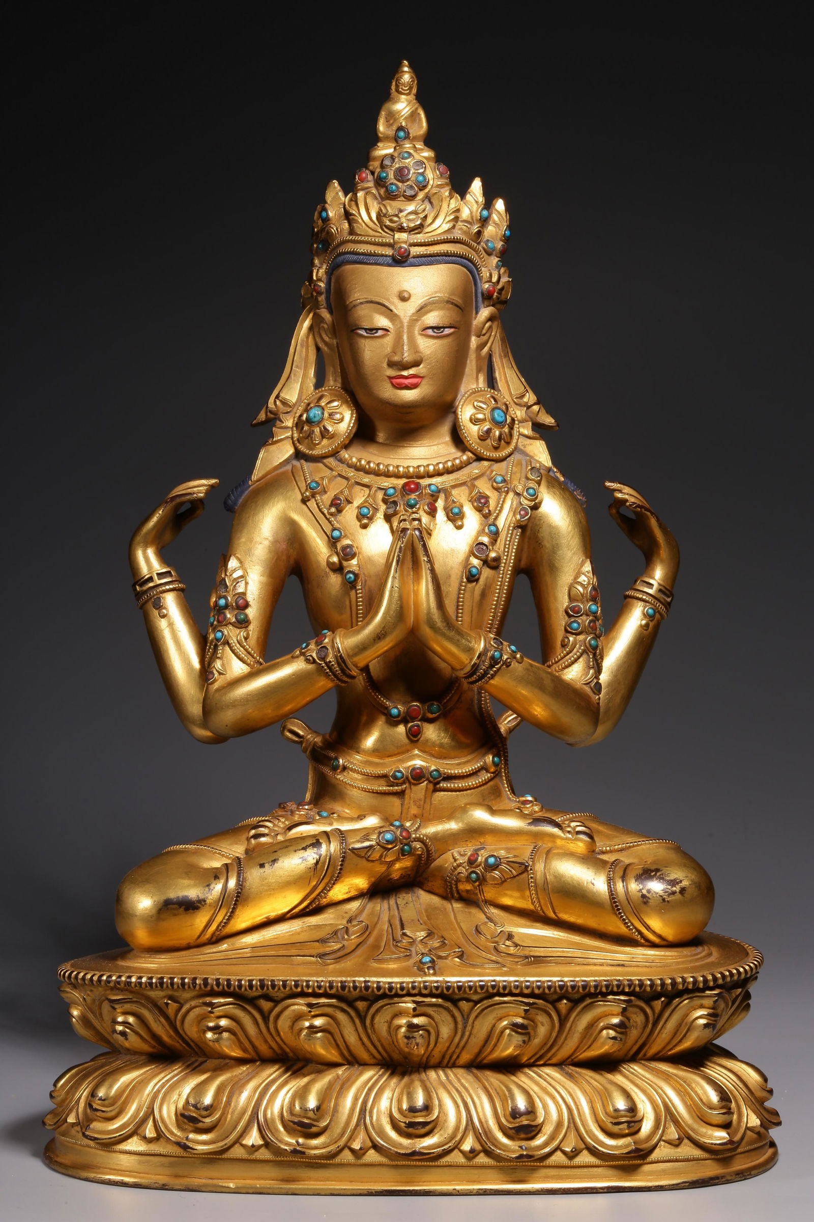 In the Qing Dynasty, a sitting statue of Guanyin with four arms inlaid with treasure and gilt copper (1 of 9)