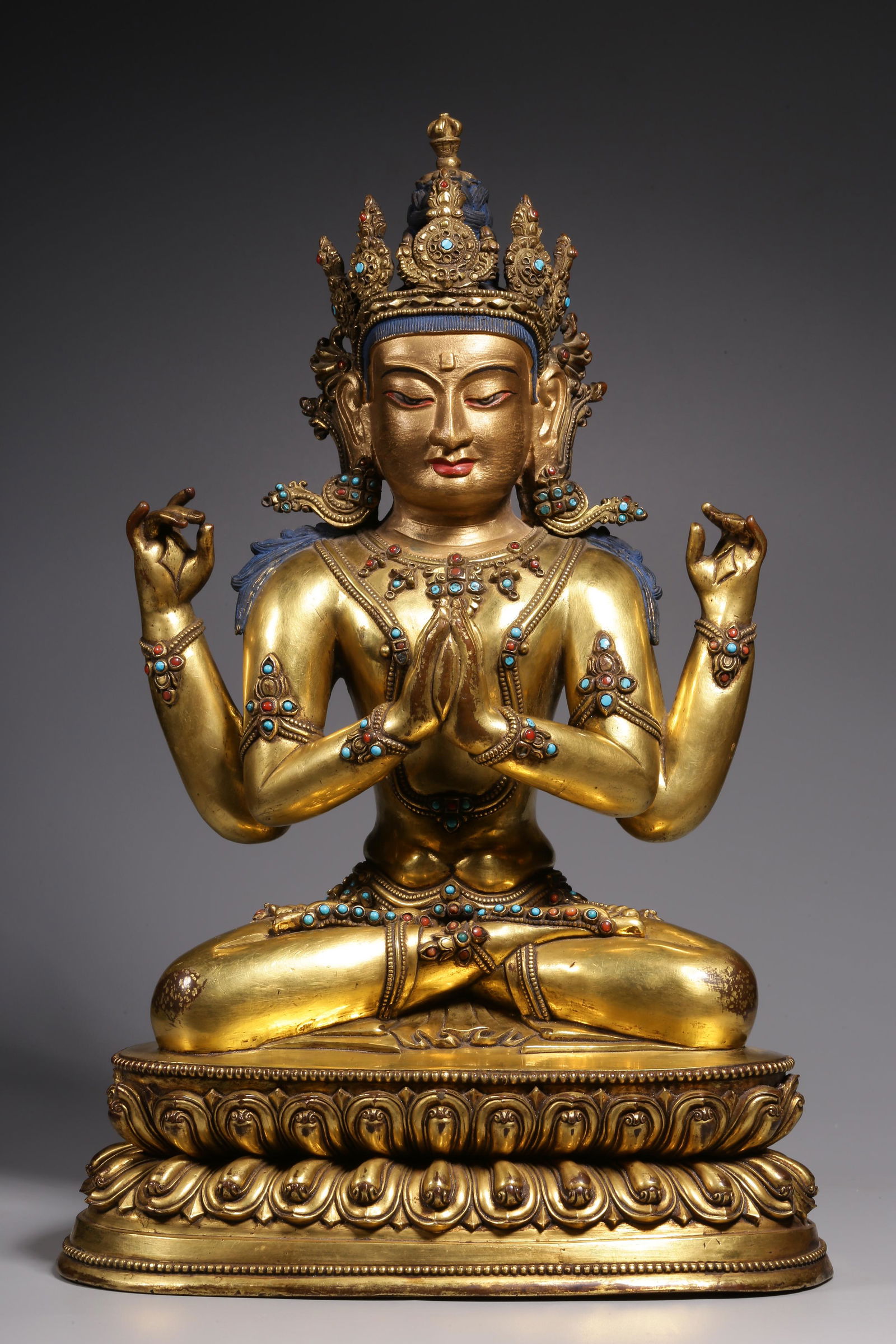 In the Qing Dynasty, a sitting statue of Guanyin with four arms inlaid with treasure and gilt copper (1 of 9)