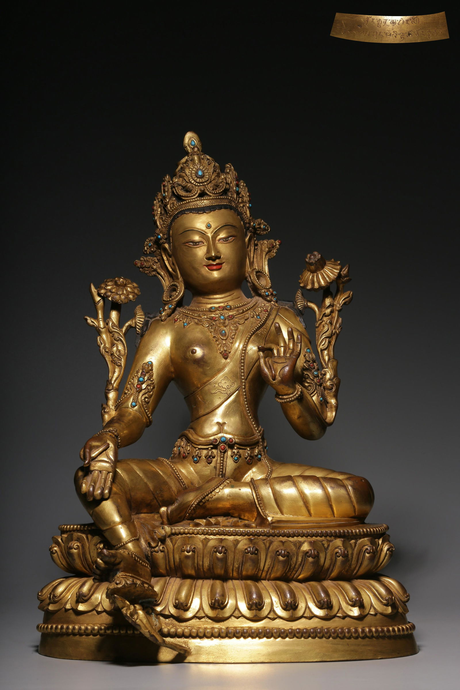 In the Qing Dynasty, a sitting Tara with gilt copper inlaid with treasure green (1 of 9)
