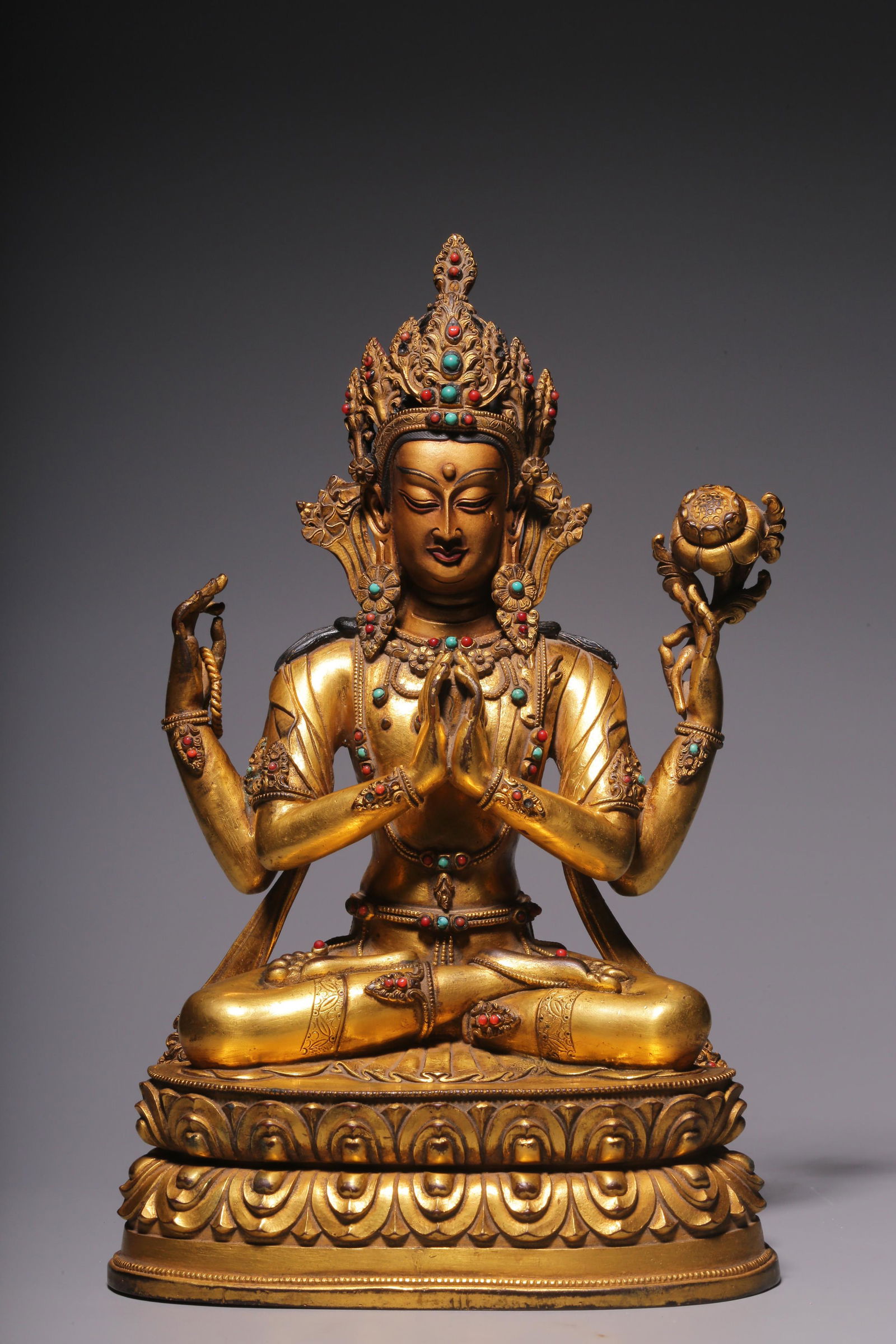 In the Qing Dynasty, a sitting statue of Guanyin with four arms inlaid with treasure and gilt copper (1 of 9)