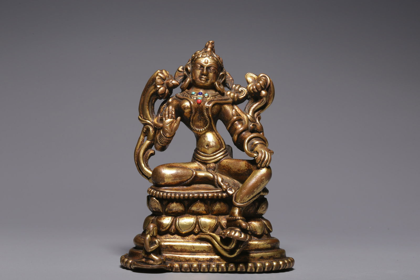 In the Qing Dynasty, a sitting Tara with gilt copper inlaid with treasure green (1 of 9)