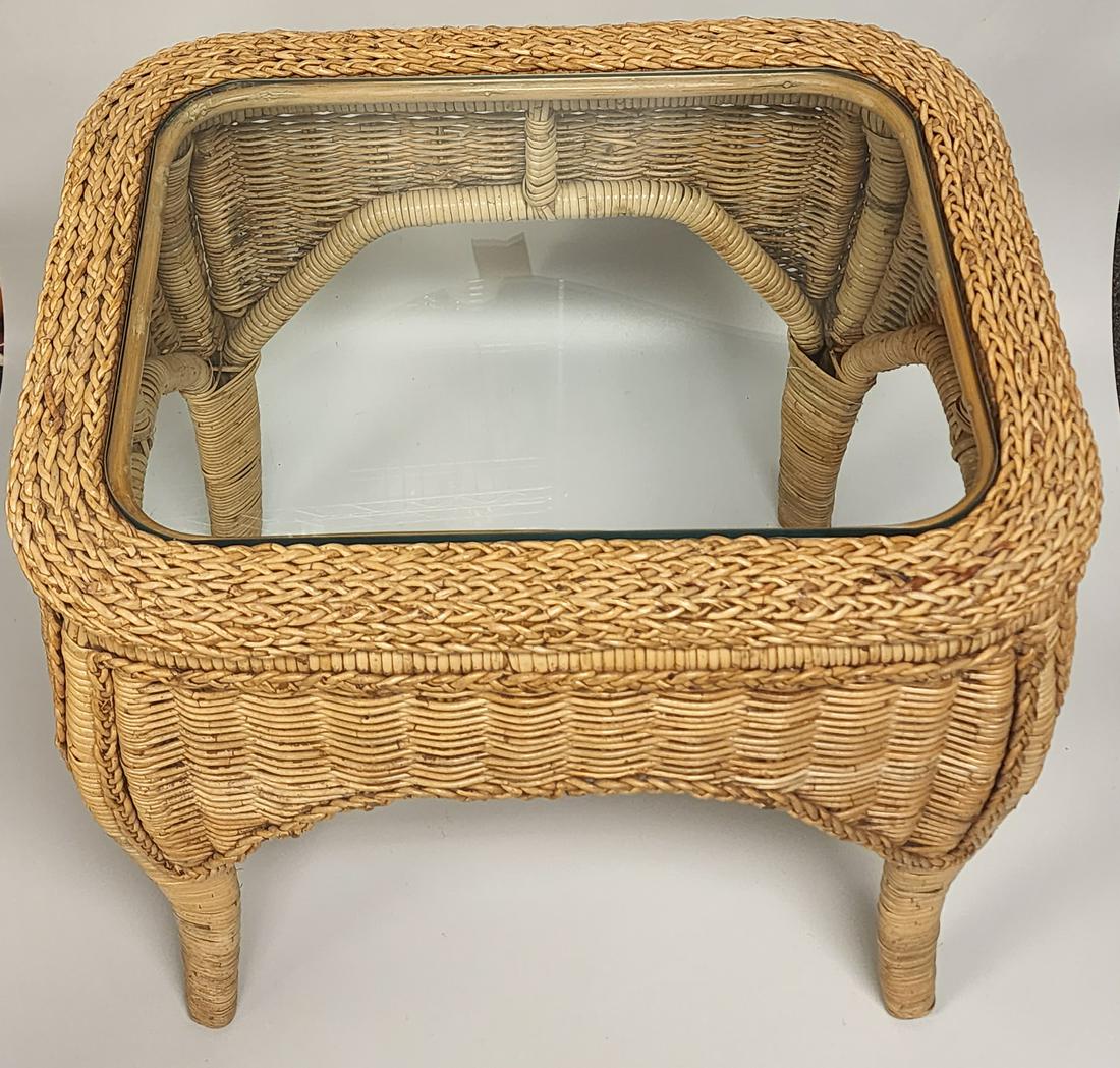Rattan Side Table: Rattan side table with glass top Dimensions: 26.5 H x 18 W x 24 D in All proceeds from our auctions support the mission of the Dorian Gray Youth Foundation and Dorian Gray Galleries by providing fundi