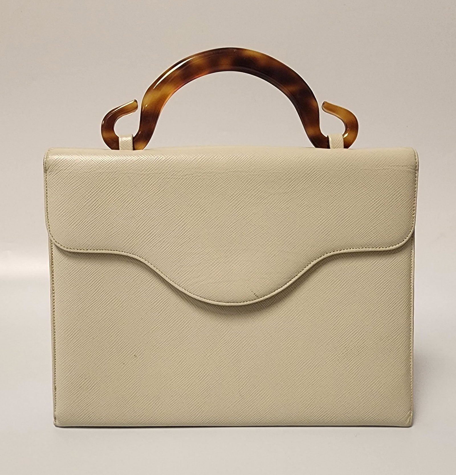 Morris Moskowitz Leather Clutch with Lucite Handle: Morris Moskowitz almond leather clutch with lucite handleAll proceeds from our auctions support the mission of the Dorian Gray Youth Foundation and Dorian Gray Galleries by providing funding and resou