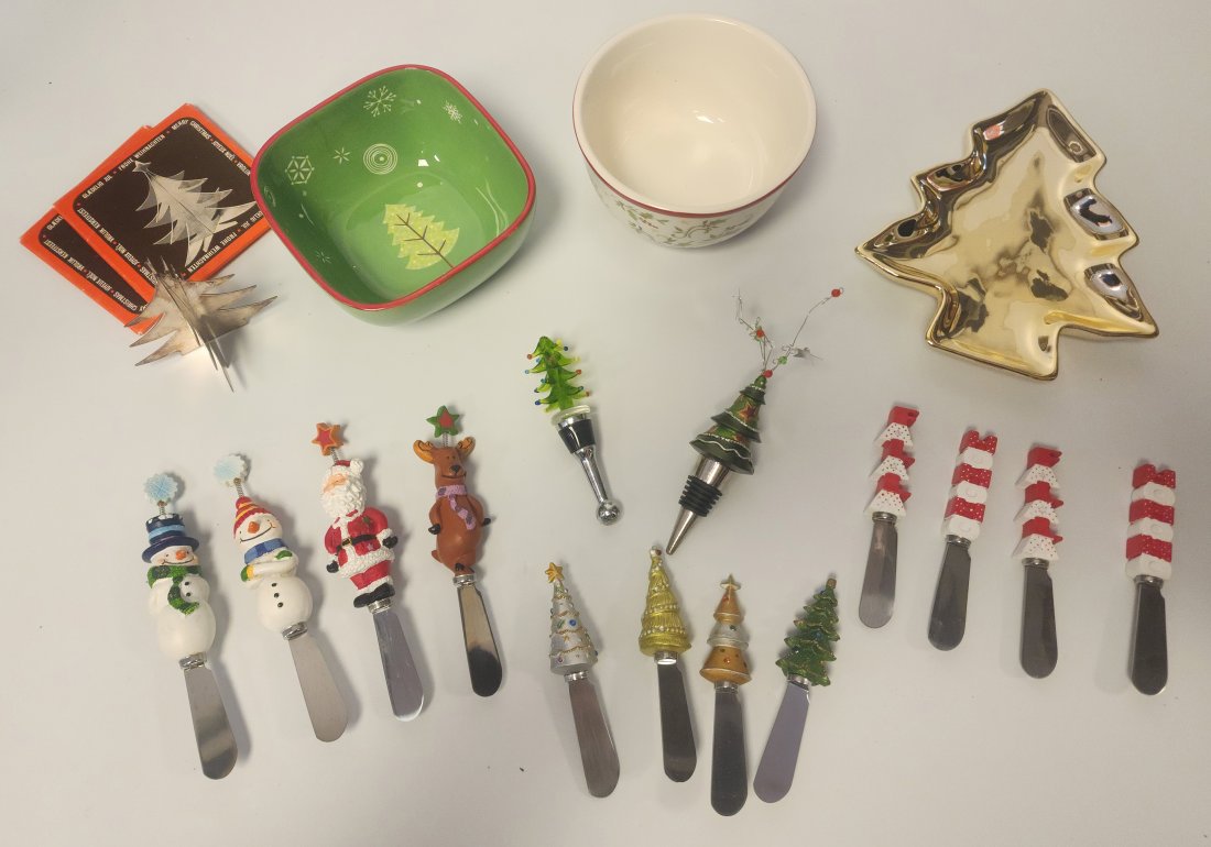 Collection of Various Christmas-Themed Serveware: Includes:- Studio Nova Christmas Tree candy trinket dish- Two holiday tree bottle stoppers- Three sets of Christmas spreader knives - Three Glaedelig Jul Frohe Weihnachten Joyeux Noel Metal Trees- Gre