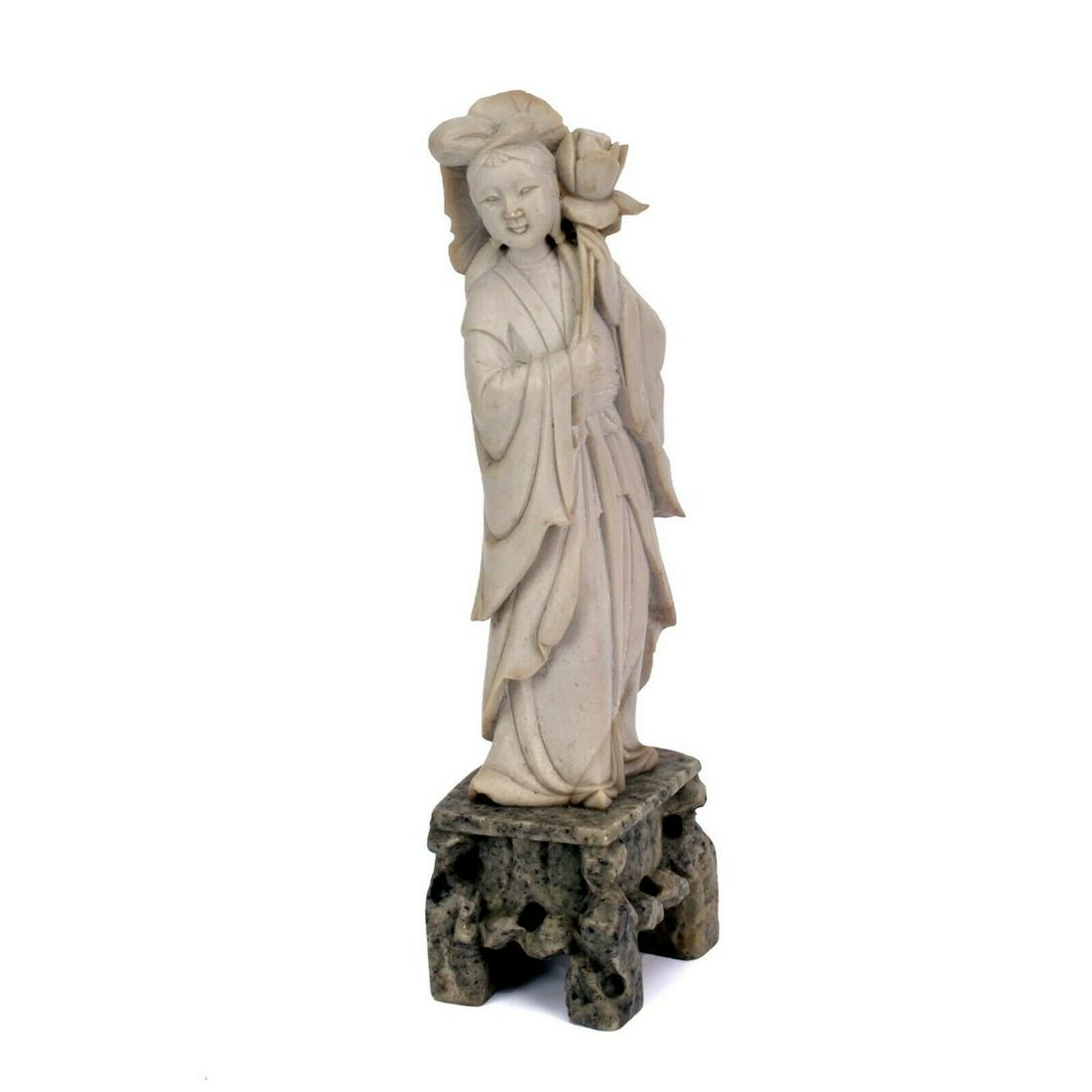 Vintage Oriental Soapstone Female Lotus Flower Figurine: Carved soapstone female figurine holding a lotus flower. Condition has flea bite on nose, on lotus flower petal and on the front of loose flowing robe. Dimensions Height: 8 in. Length: 2 in. Approxima
