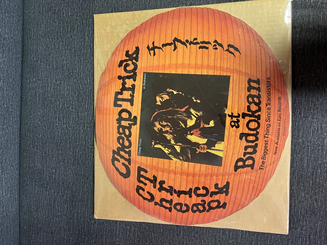 1979 Cheap Trick at Budokan Album Release Cardboard Sign: 1979 Cheap Trick at Budokan Album Release Cardboard Sign Epic Records 1979 Slight crease near upper left side Light edge wearMinimal to no other visible damage